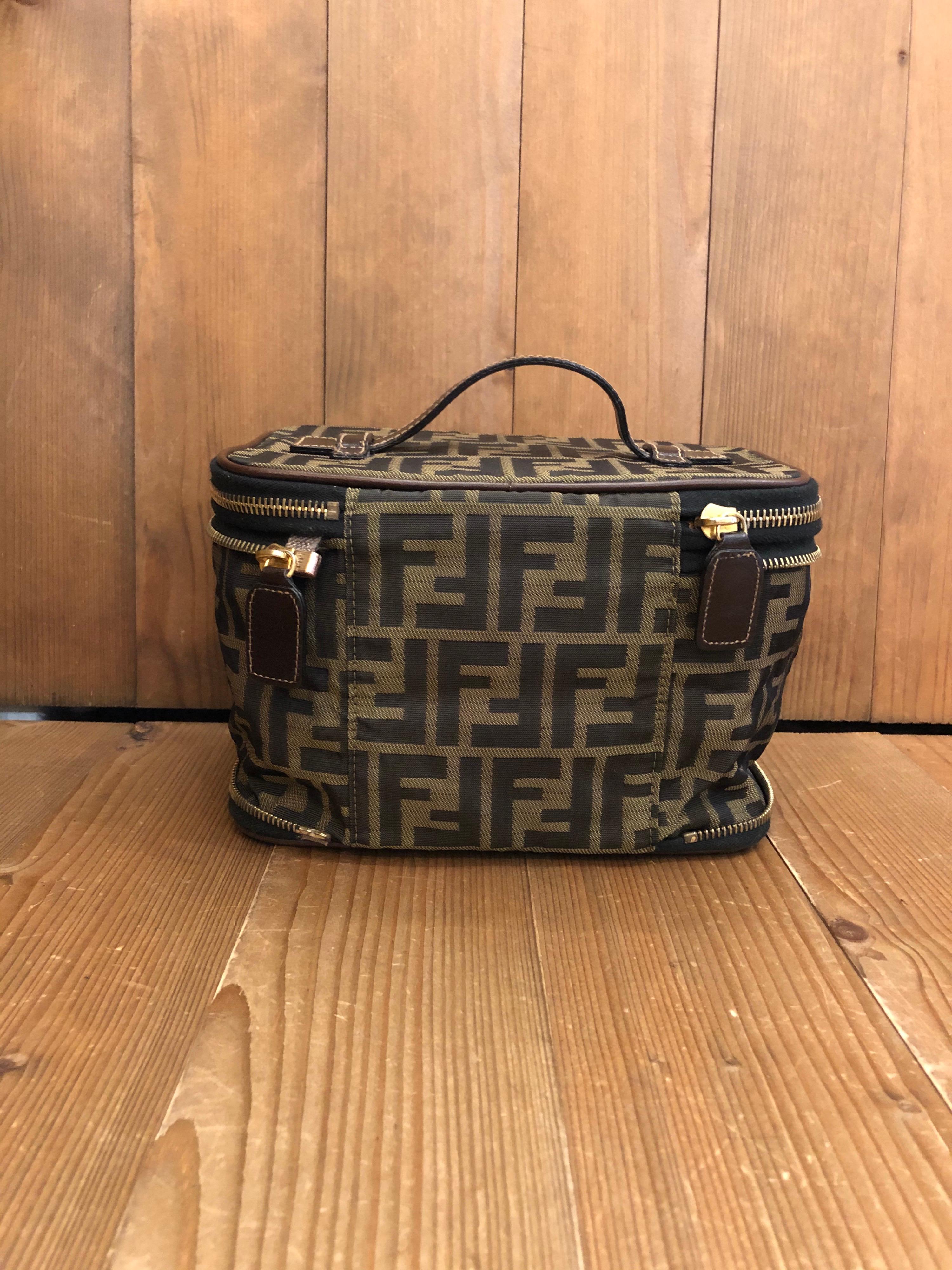 FENDI Brown Zucca Jacquard Foldable Cosmetic Vanity Pouch Handbag. Made in Italy. Measures  8.25 x 5.5 x 6 inches 
Material: Jacquard/Leather

Condition:
Outside: Minor signs of wear on jacquard and leather trimmings.
Inside: Clean with minor signs
