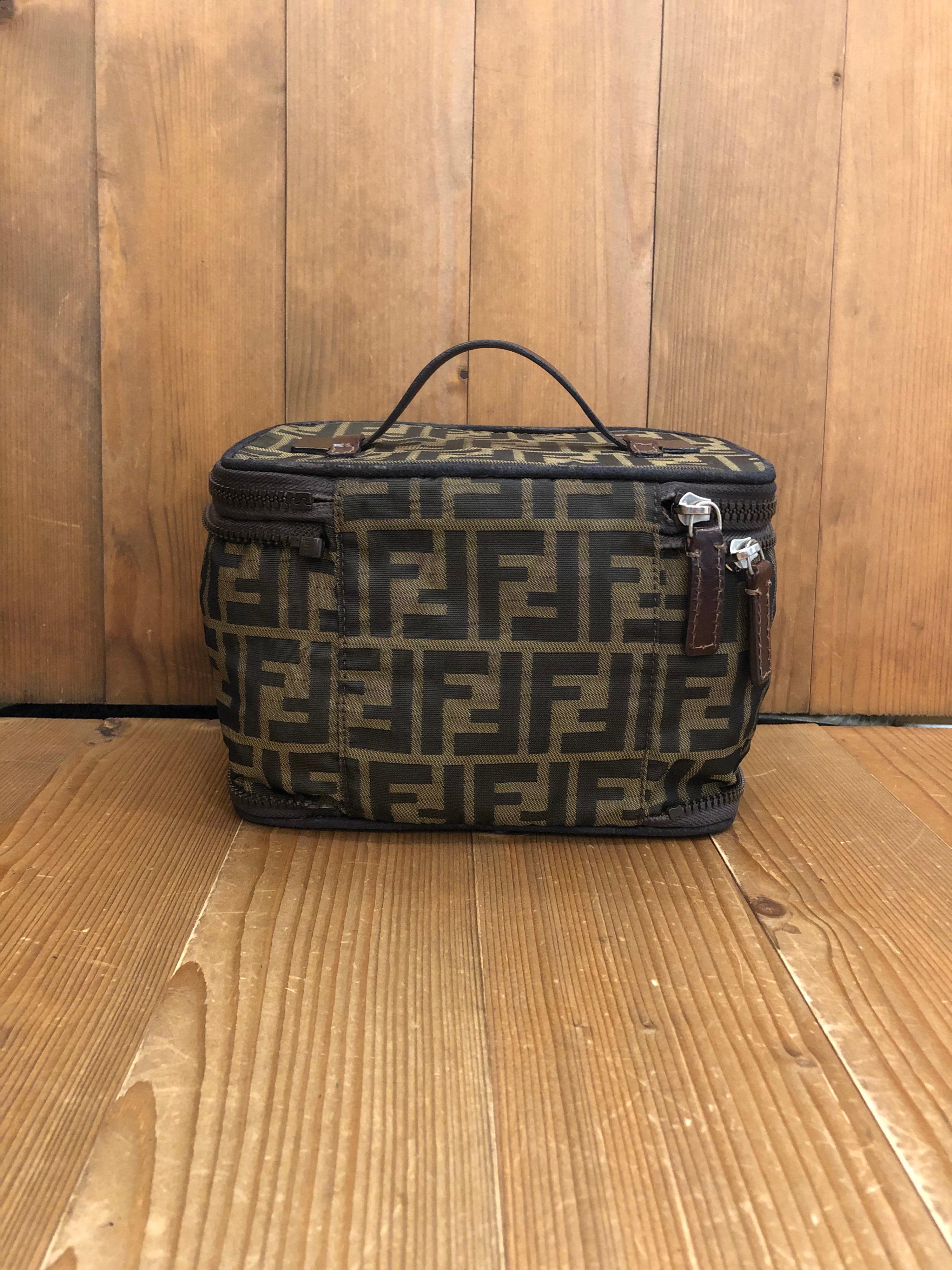 1990s FENDI Brown Zucca Jacquard Foldable Cosmetic Vanity Pouch Handbag 

Material: Jacquard/Leather
Color: Brown
Origin: Italy
Measurements: 8.25