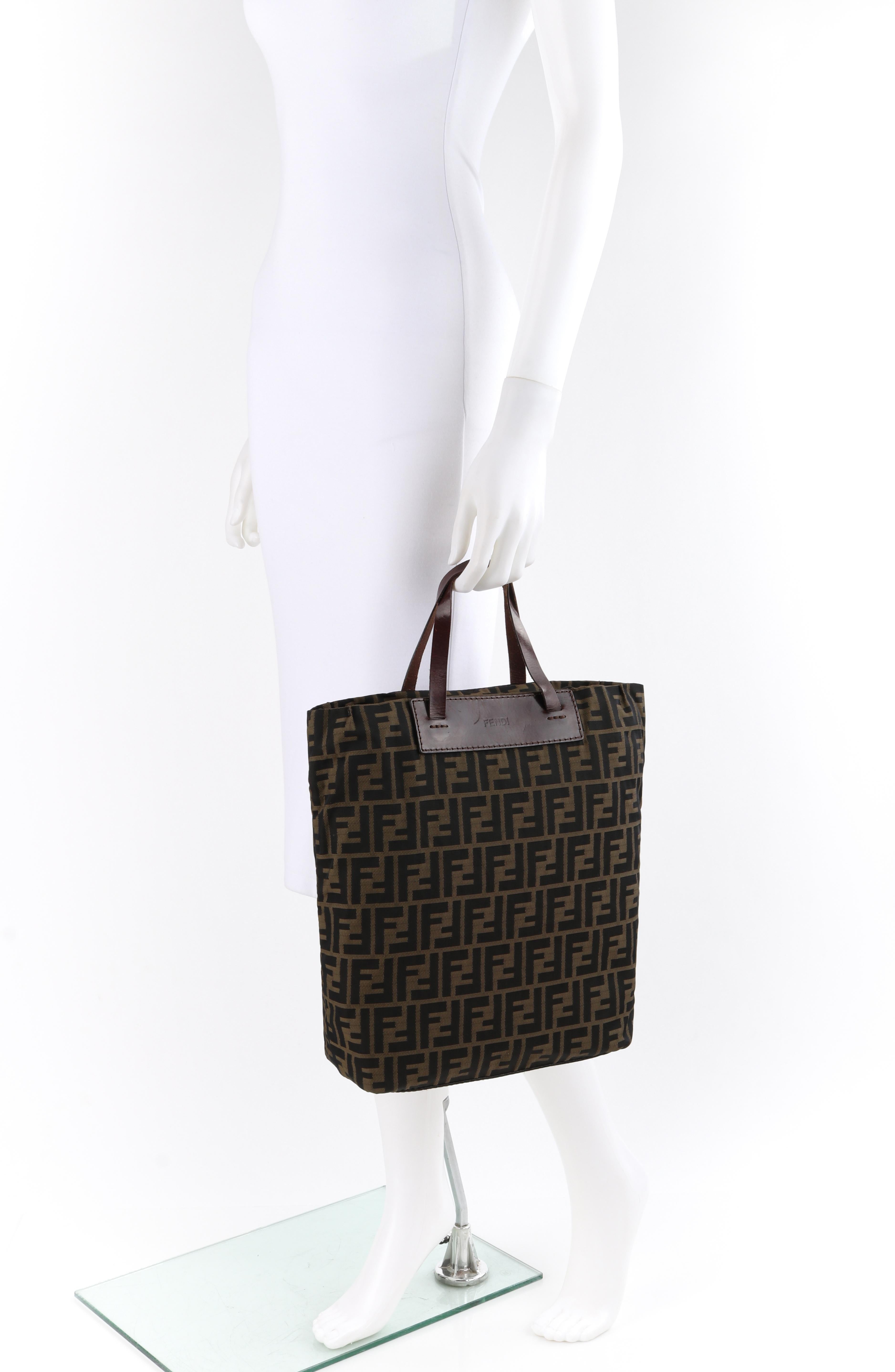 FENDI Brown Zucca Monogram Canvas Dual Handle Foldable Shopping Tote
  
Brand / Manufacturer: Fendi
Designer: Karl Lagerfeld
Style: Tote
Color(s): Shades of brown, black (exterior, interior); gold (hardware)
Lined: No
Unmarked Fabric Content: Canvas