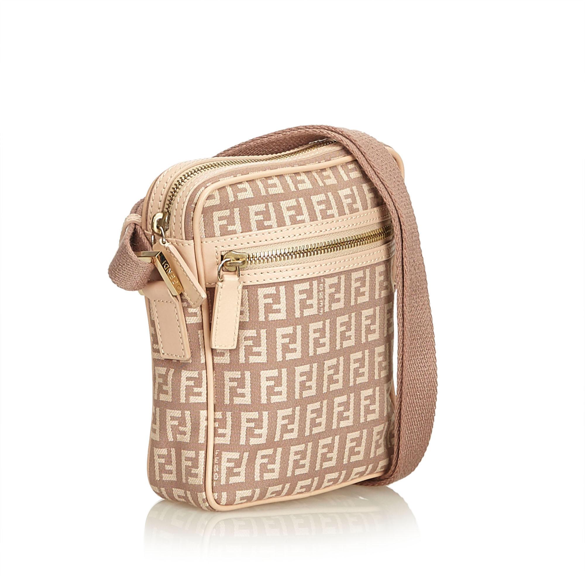 This crossbody features a jacquard body with leather trim, exterior front zip pocket, adjustable shoulder strap, top zip closure, and interior slip pocket. It carries as AB condition rating.

Inclusions: 
Dust Bag

Dimensions:
Length: 19.00