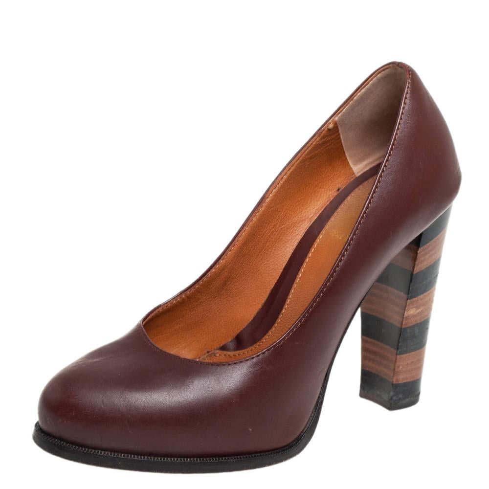 These Fendi pumps are your top choice if youâ€™re looking to add some touch of classic style to your outfit. The pair has been made in Italy from burgundy leather and set on signature pequin striped heels.
