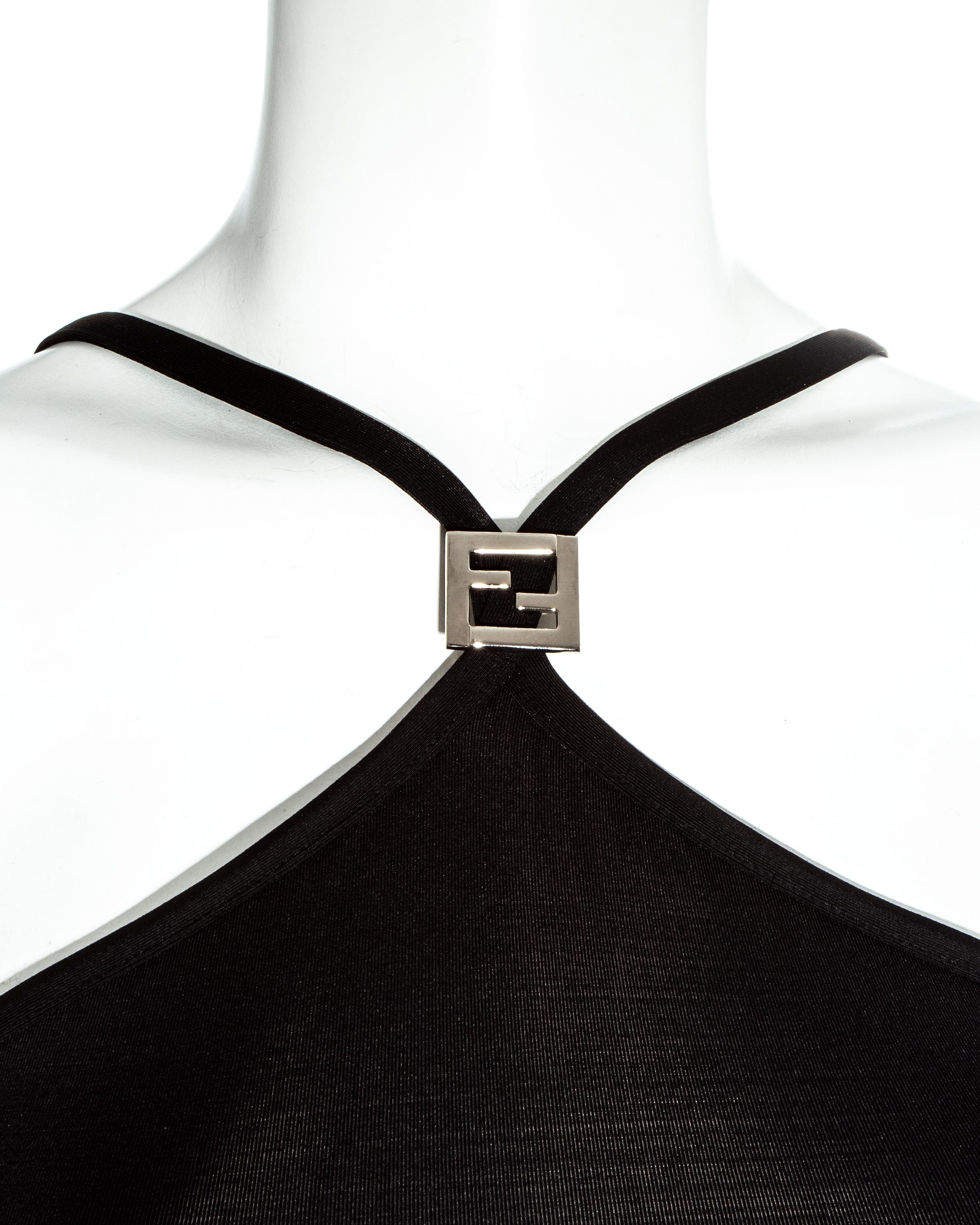Fendi by Karl Lagerfeld; black lycra figure hugging maxi dress with silver metal Fendi logo

Spring-Summer 1997