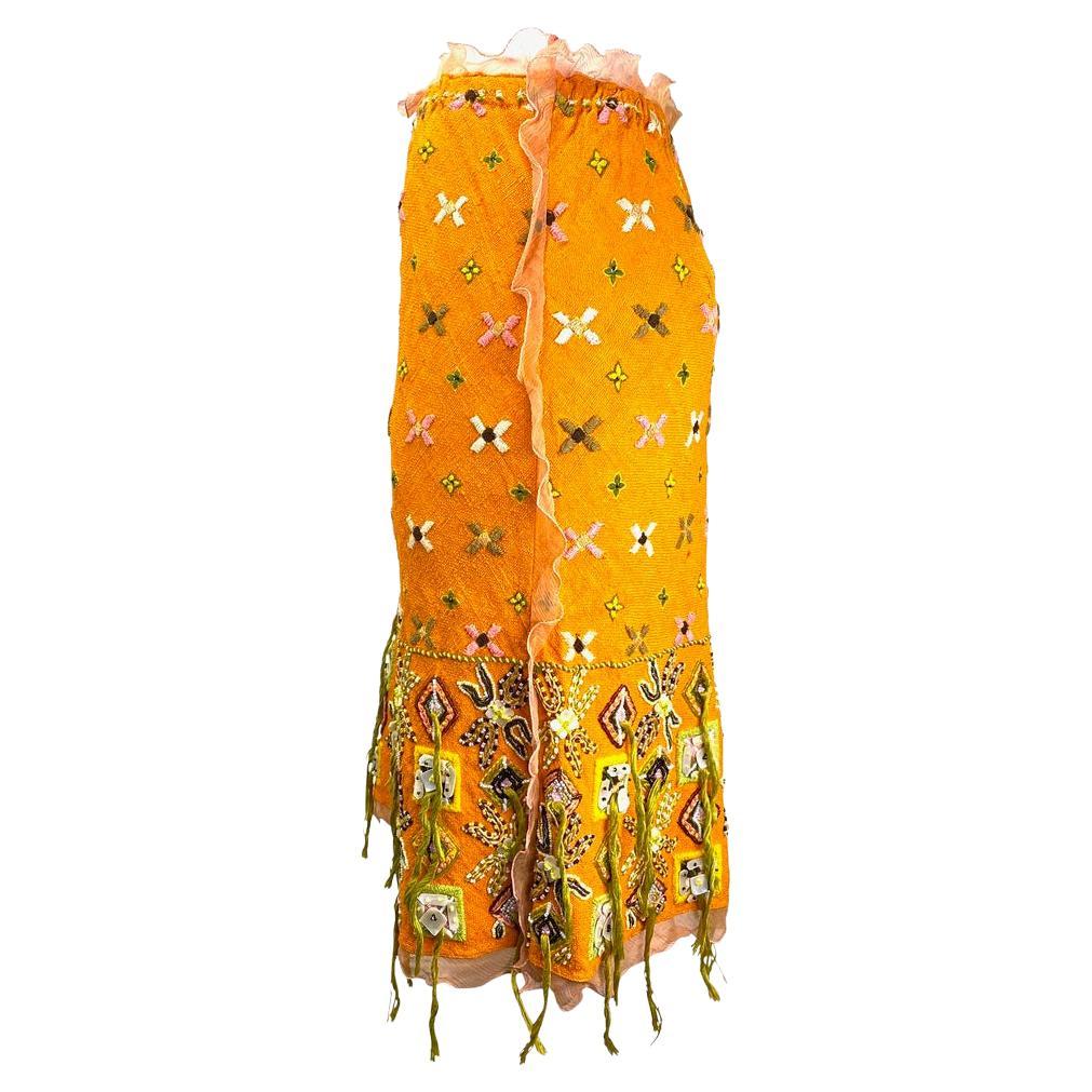Presenting an incredible orange embellished Fendi skirt, designed by Karl Lagerfeld. From the Spring/Summer 2000 collection, this skirt is heavily embellished with ruffled chiffon seed beads, mother-of-pearl accents, and strands of vibrant fringe.