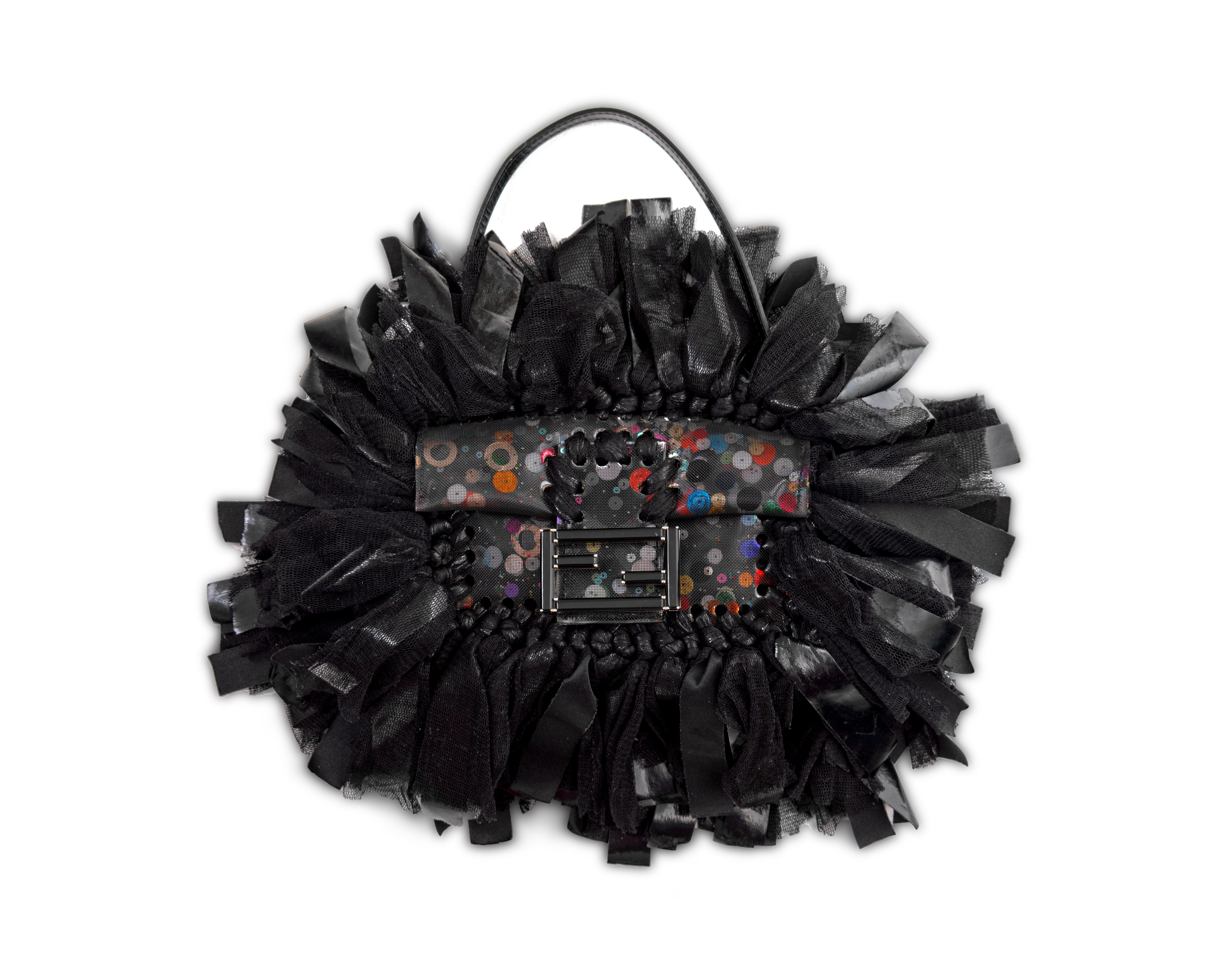 ▪ Fendi evening mini baguette bag
▪ Creative Director: Karl Lagerfeld 
▪ Sold by One of a Kind Archive'
▪ c. 2000
▪ Limited edition artisanal piece 
▪ Hand woven pvc-coated and silk mesh tassels 
▪ Constructed from black plastic mesh
▪ Incased