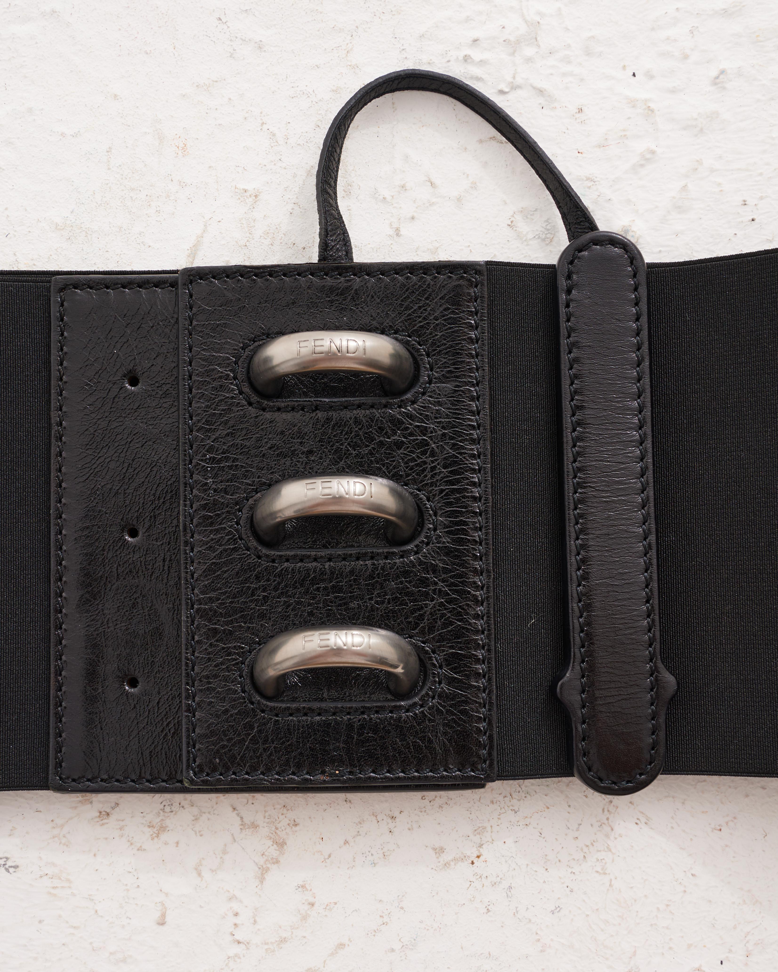- Designed by Karl Lagerfield
- Sold by Skof.Archive
- Early 00’s
- Black Leather Waistband
- Metal Applications with “FENDI” Logo
- Excellent Condition
- Made in Italy
- Materials: Leather
- Size: FR 32 - IT 36 - UK 4 
- Measurements: 70 cm / 28 in