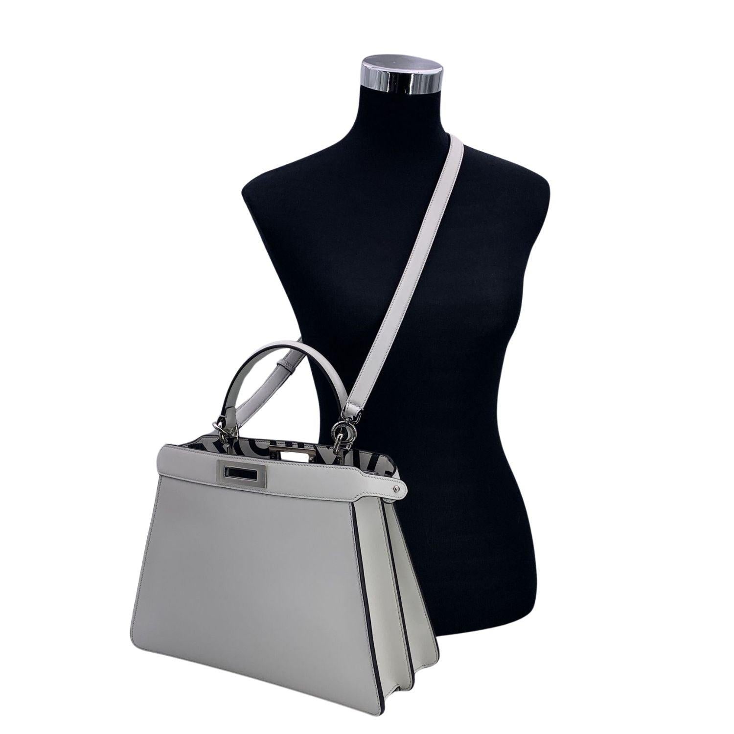 Beautiful Fendi by Marc Jacobs 'Medium - Peekaboo ISeeU' Bag in white leather. The bag features 2 compartments divided by a rigid partition. Turn lock closure with black and white exclusive 'FENDI ROMA' pattern. Silver metal hardware. Top carry
