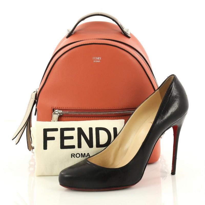 This authentic Fendi By The Way Backpack Leather Mini presented in the brand's 2015-2016 Collection balances a luxurious, playful style made for on-the-go fashionistas. Crafted from orange leather, this backpack features a flat top-handle with