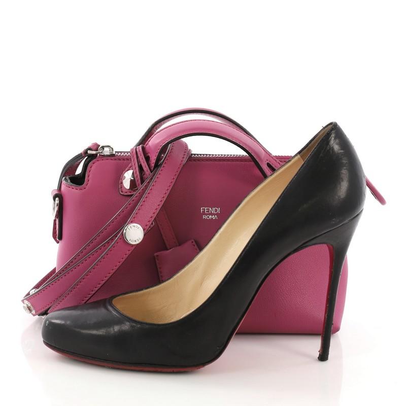 This Fendi By The Way Satchel Calfskin Mini, crafted from fuschia calfskin leather, features dual flat leather top handles, stamped Fendi foil logo, and silver-tone hardware. Its top zip closure opens to a gray fabric interior with middle zip