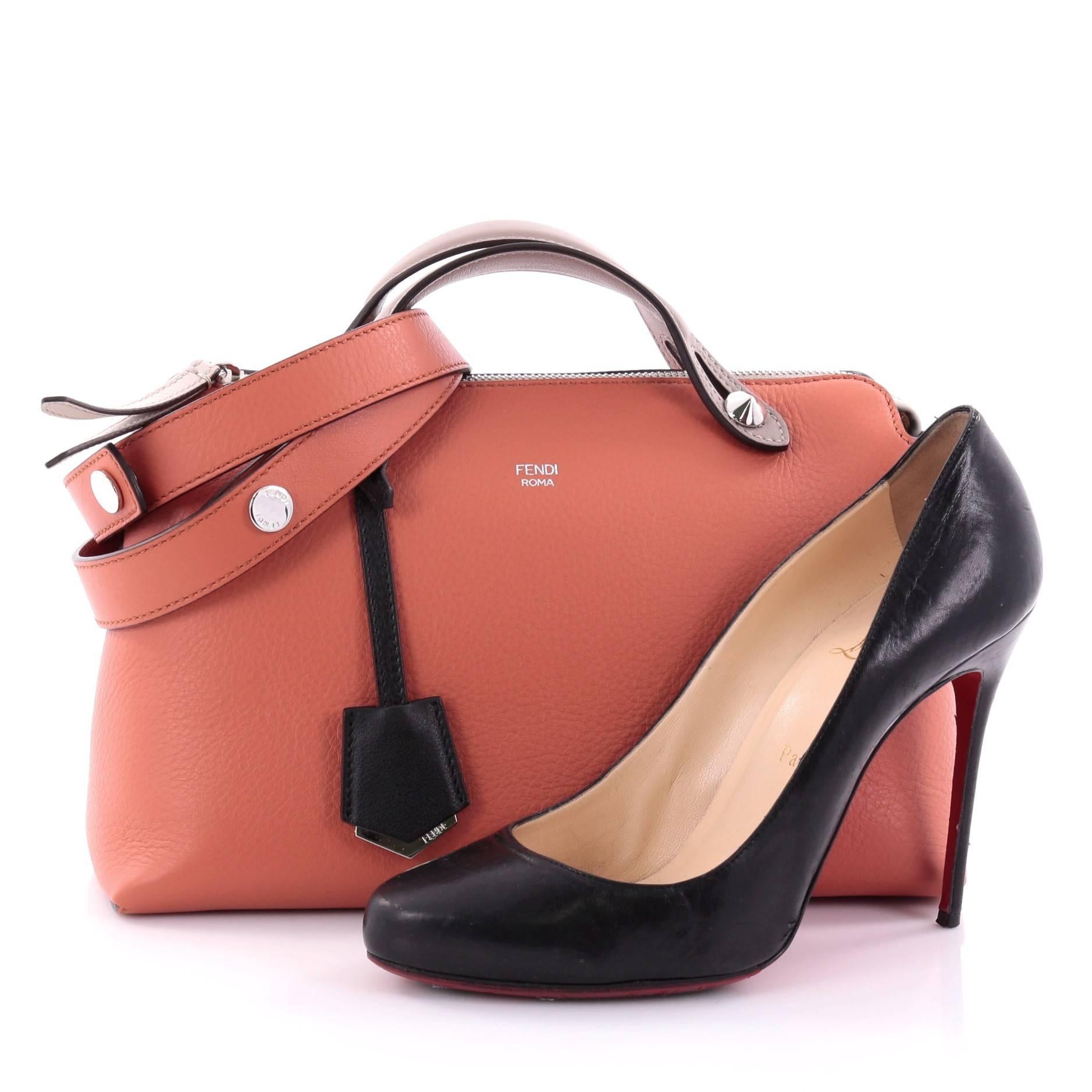 This authentic Fendi By The Way Satchel Calfskin Small showcases a modern understated style admired by every fashionista. Constructed from coral calfskin leather, this minimalist and functional duffle features dual flat leather top handles, stamped