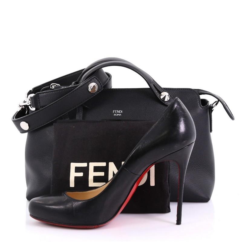 This Fendi By The Way Satchel Calfskin Small, crafted from black calfskin leather, features dual flat leather top handles, stamped Fendi foil logo, and silver-tone hardware. Its top zip closure opens to a black fabric interior with a center zip