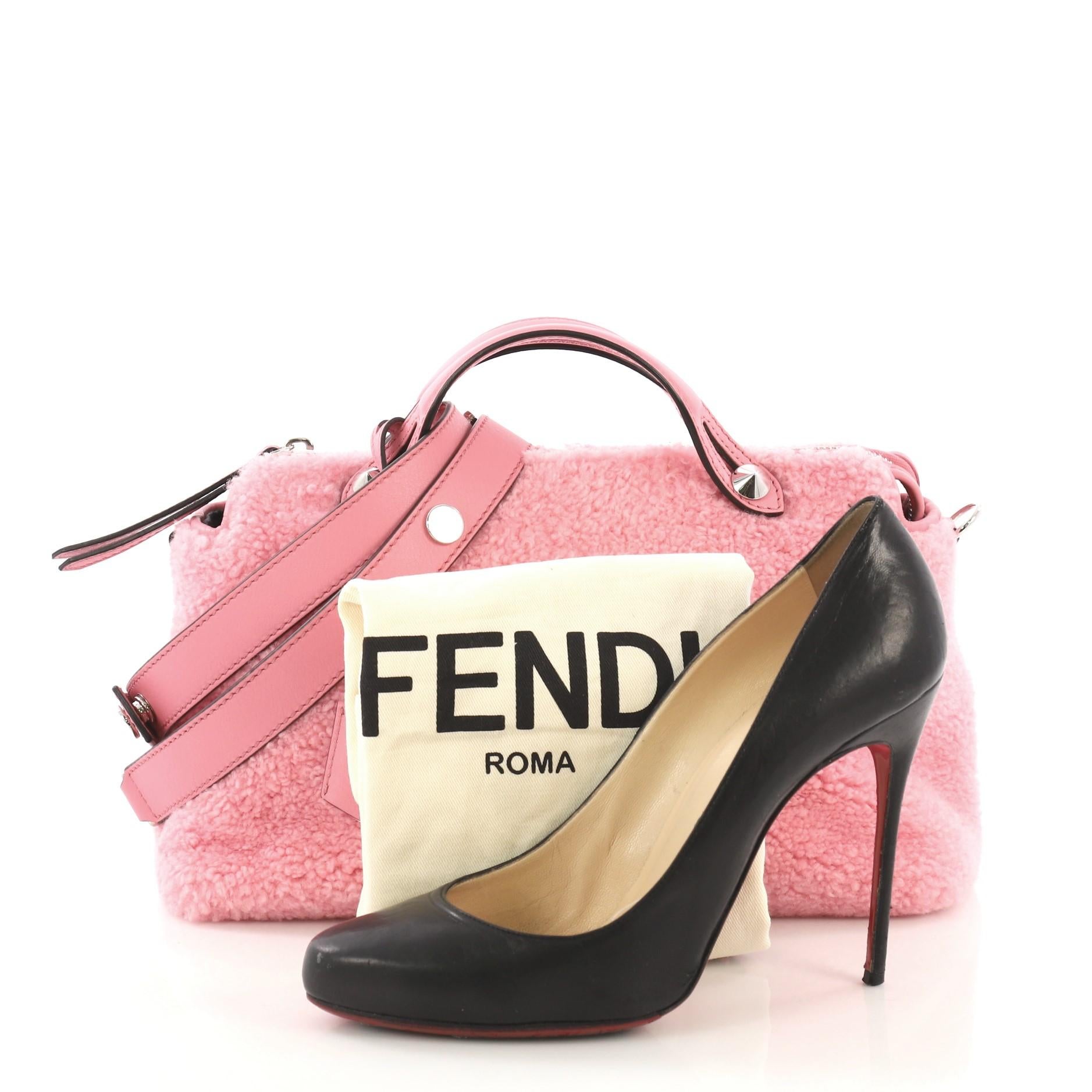 This Fendi By The Way Satchel Shearling Small, crafted from pink shearling, features dual flat top handles and silver-tone hardware. Its top zip closure opens to a gray fabric interior with a center zip compartment and slip pockets. **Note: Shoe