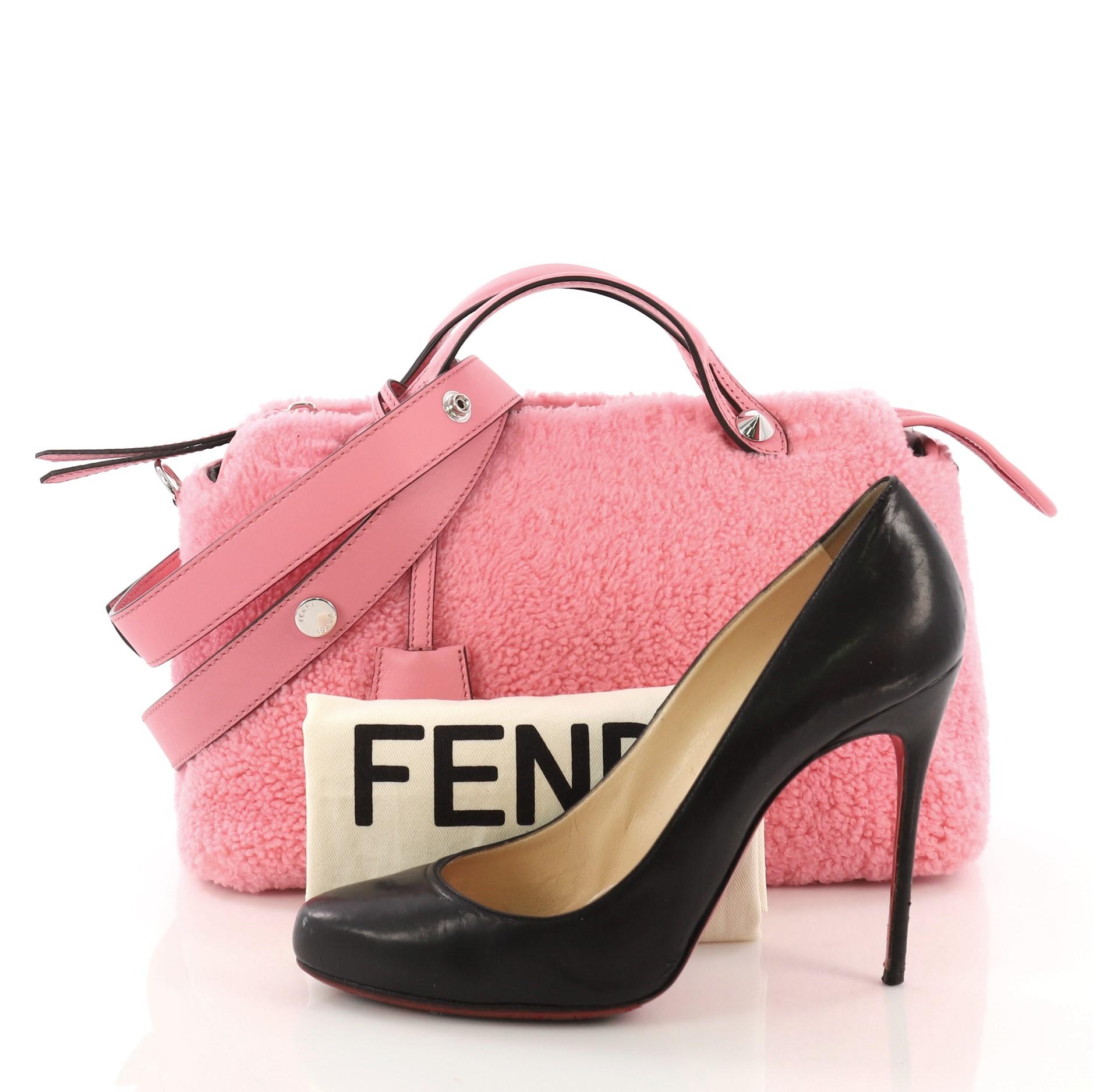This Fendi By The Way Satchel Shearling Small, crafted from pink shearling, features dual flat top handles and silver-tone hardware. Its top zip closure opens to a dark gray fabric interior with a center zip compartment and slip pockets. **Note: