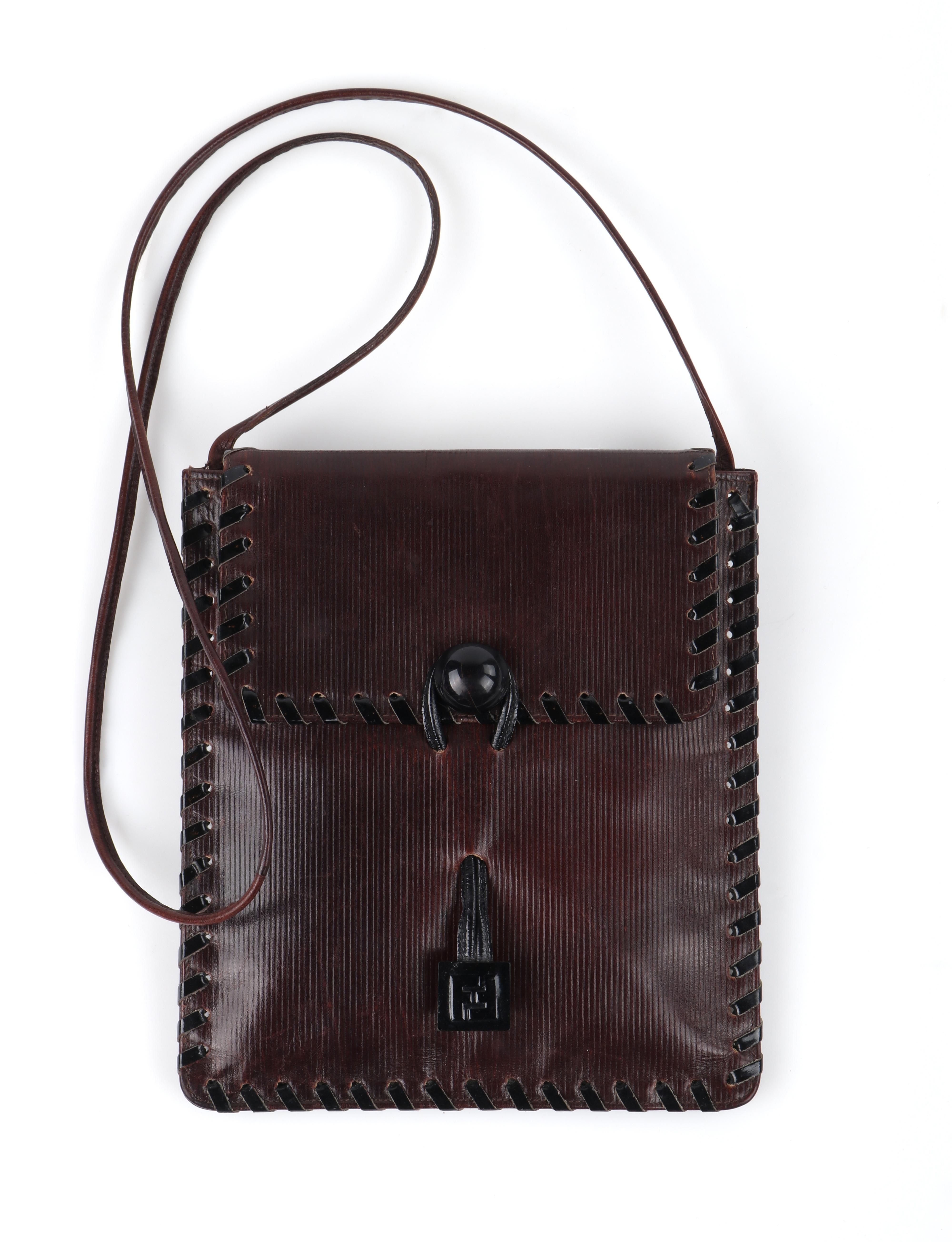 A very rare Fendi circa late 1970's early 1980's vintage shoulder crossbody bag. Front flap is secured closed by a drawstring style patent leather cord that loops around a solid ball accent at front. Drawstring cord has the iconic FF Fendi symbol