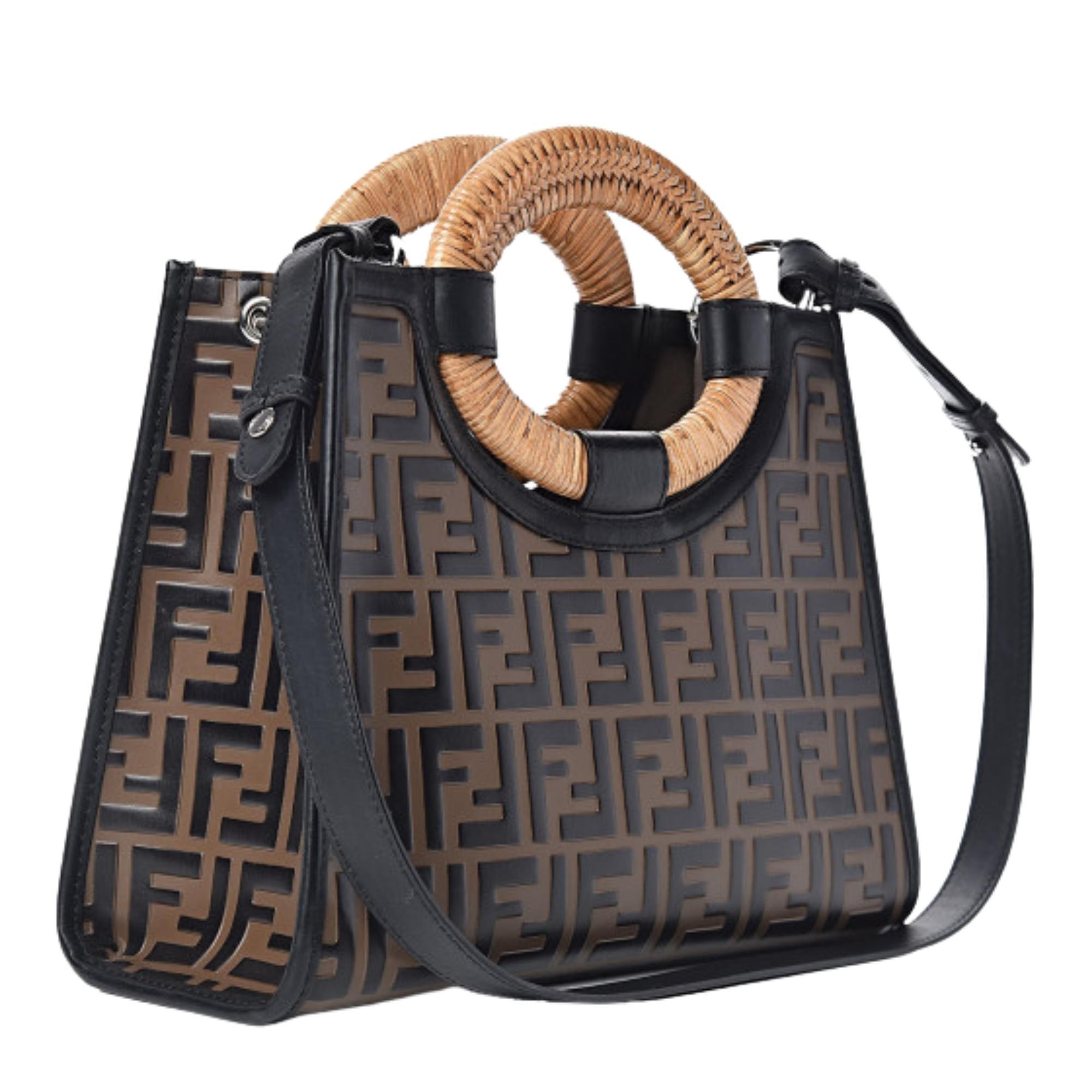 This tote is constructed with brown calfskin leather with black FF logo embossing and smooth black leather trim. The bag features dual large rounded wicker top handles with braided detail, an optional black leather shoulder strap, front zip pocket,