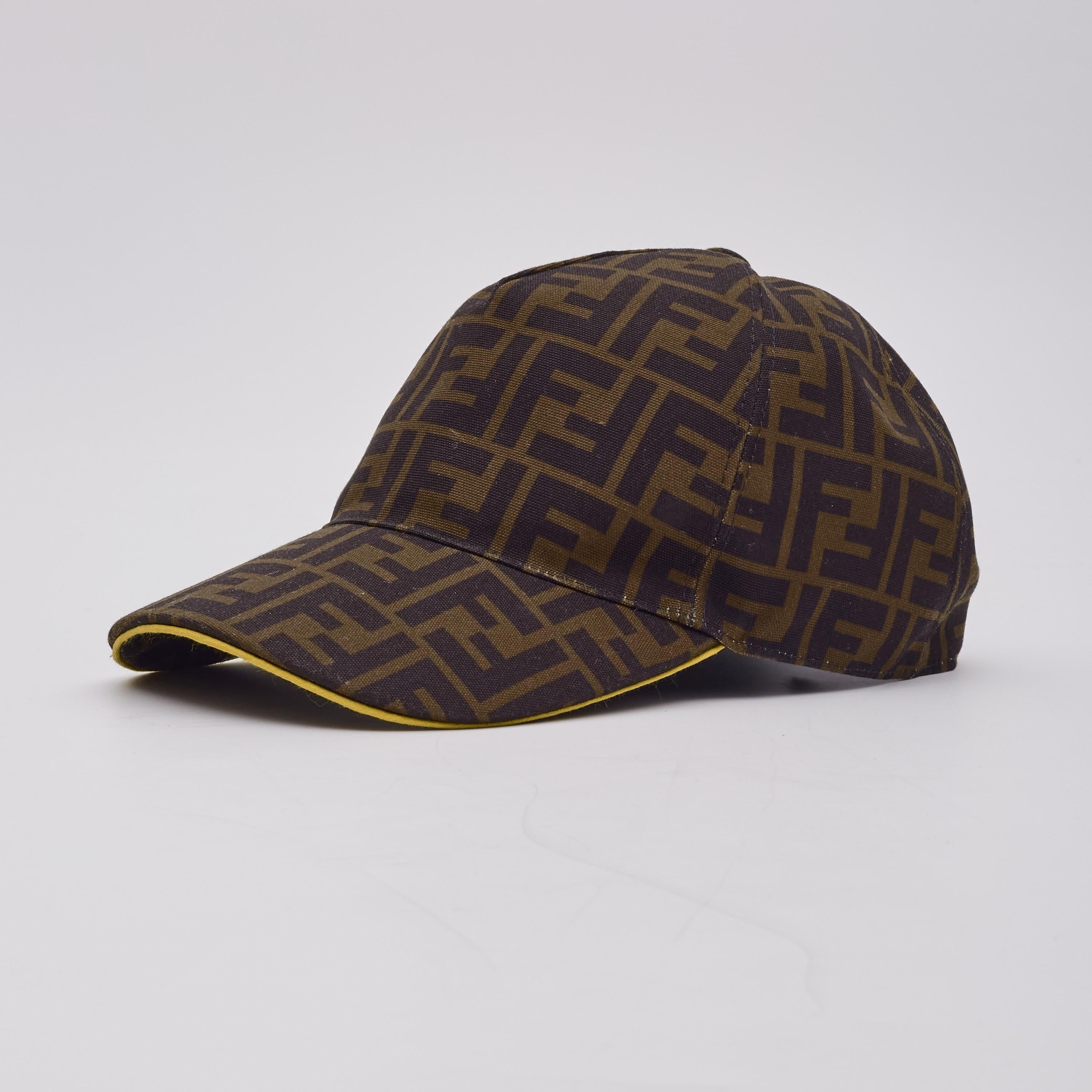 This stylish cap is made of Fendi zucca monogram canvas. The interior is lined with black fabric and the hat features contrasting yellow trim.

Color: tobacco brown with black ff jacquard and yellow trim
Material: 100% polyester
FXQ768