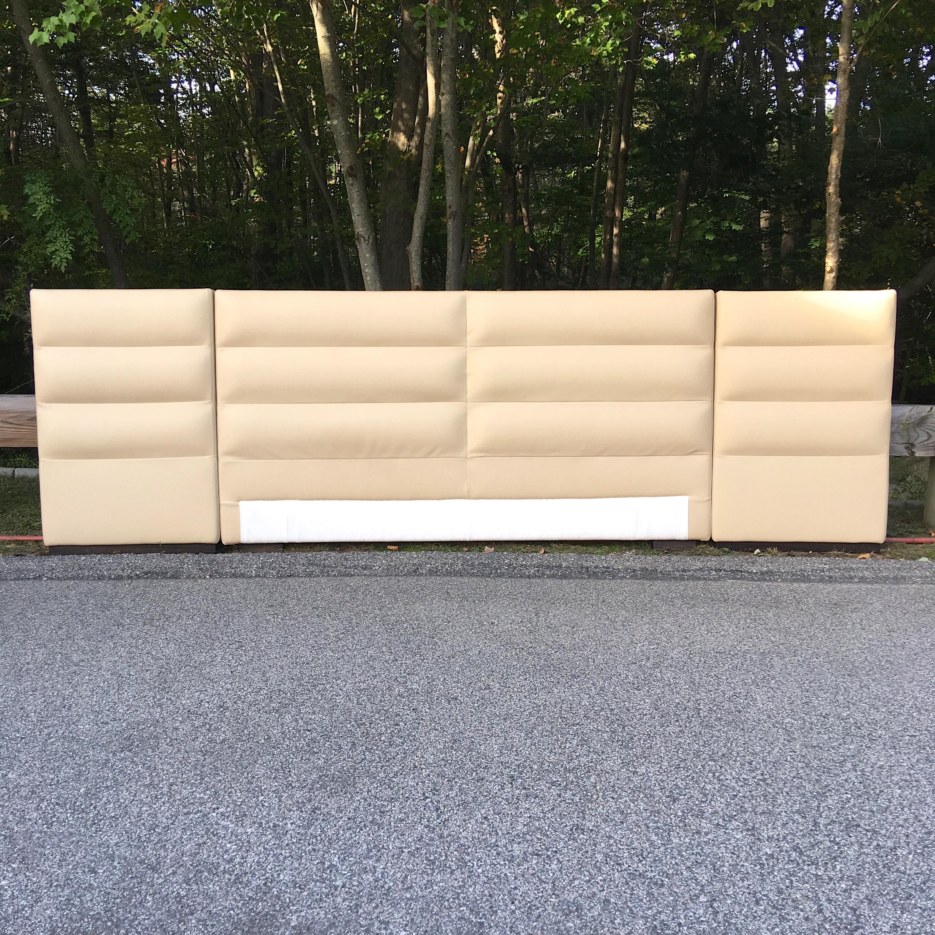 Opulent Fendi Casa light beige Italian leather channel tufted upholstered king-size headboard and integrated nightstands. Excellent condition.
Headboard is three upholstered leather sections, each on ebonized ash bases and have Fendi logo dust cover