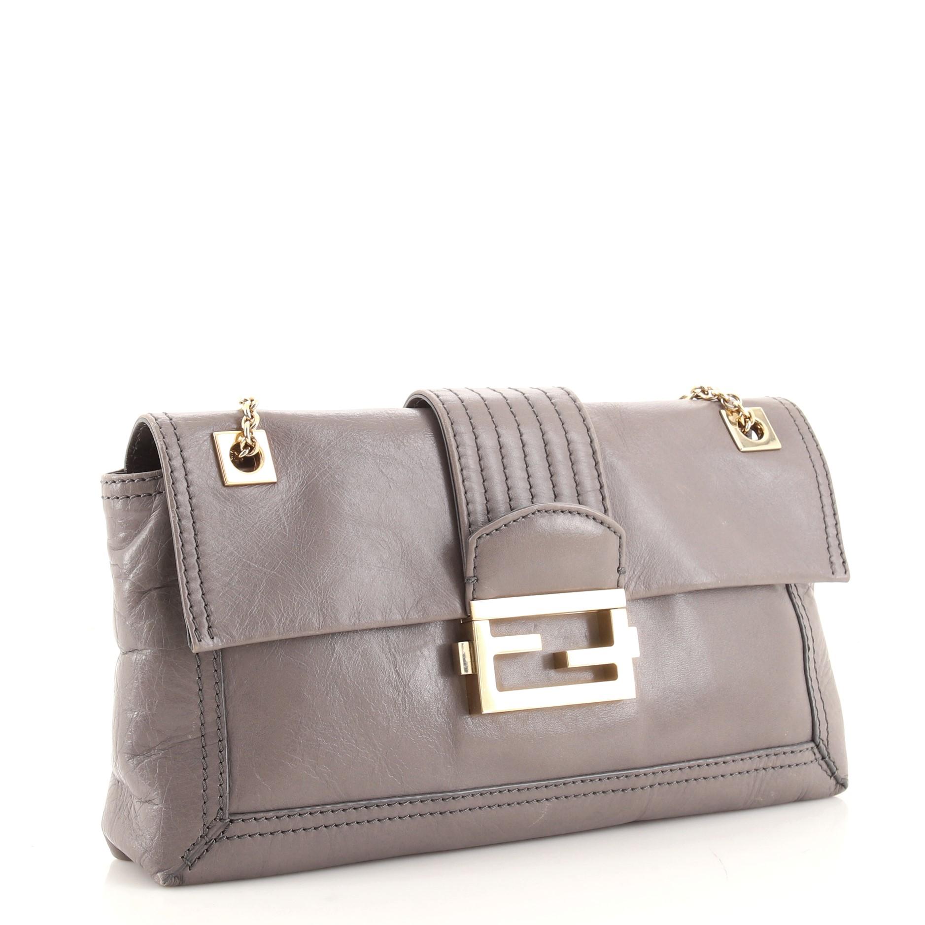 Condition: Good. Moderate creasing, wear and scuffs on exterior, shoulder pad and underneath flap, cracking, heavy splitting and peeling on shoulder pad wax edges. Small glue stains on side opening edges, wear in interior, scratches and