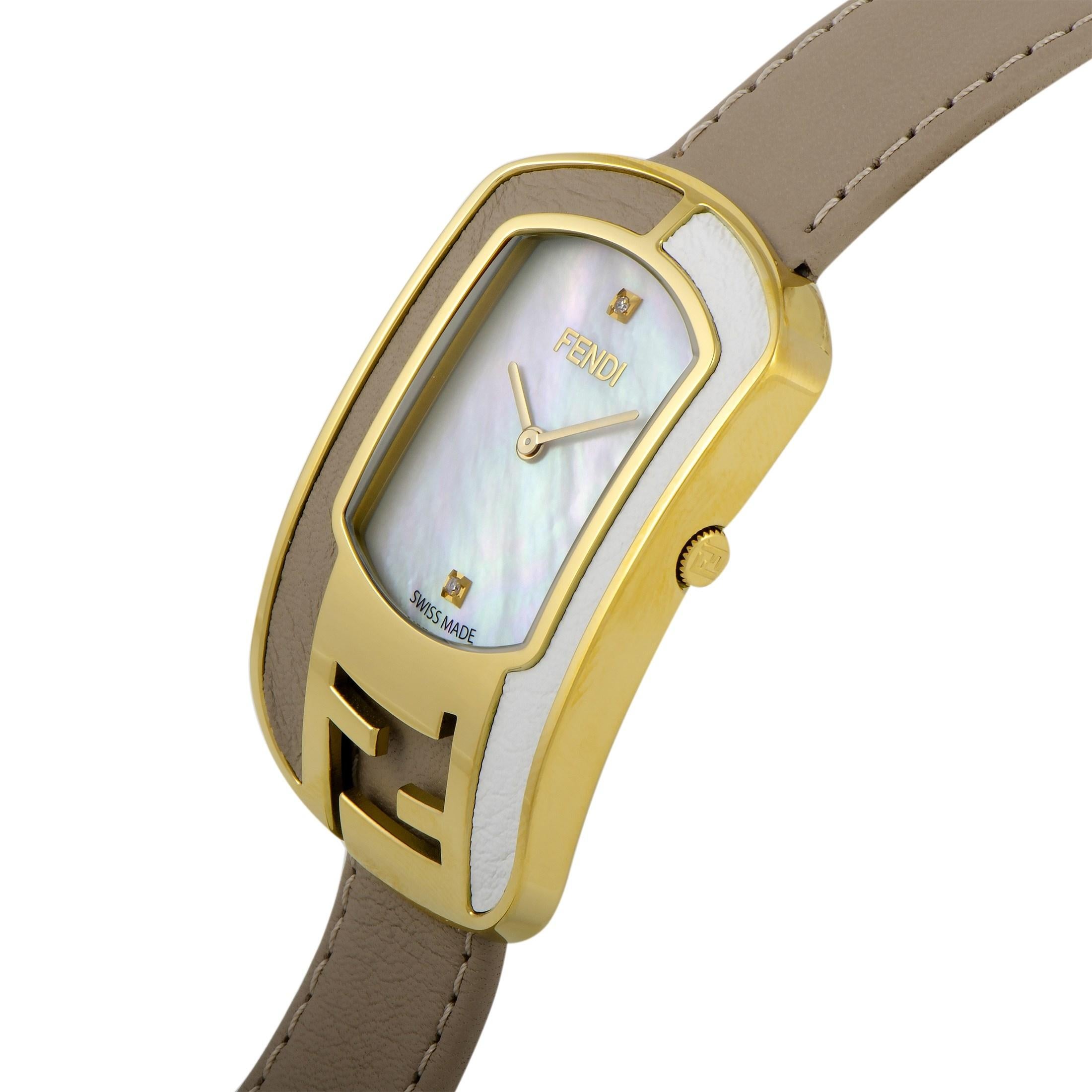 This is the Fendi Chameleon watch, reference number F336434561D1.

It is presented with a gold-tone stainless steel case that offers water resistance of 30 meters. The watch is worn on a taupe leather strap fitted with a tang buckle. The mother of