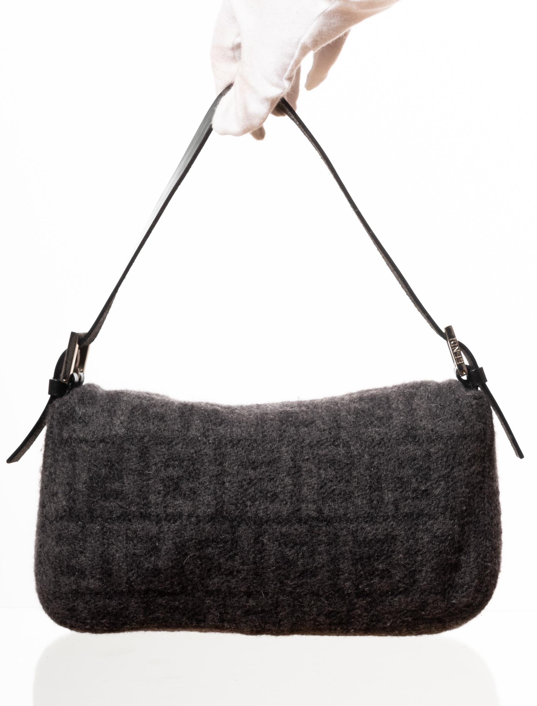 Iconic Fendi baguette made with charcoal coloured cashmere with Fendi zucca monogram print. Featuring black leather finishes, sliver tone hard ware, front flap with snap closure, silver FF logo metal plate at closure and a flat leather handle.