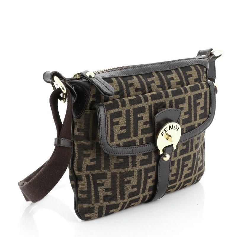 This Fendi Chef Zip Crossbody Bag Zucca Canvas, crafted from brown zucca canvas, features adjustable leather strap, leather trim and gold-tone hardware. Its zip closure opens to a neutral fabric interior. 

Condition: Excellent. Creasing on leather
