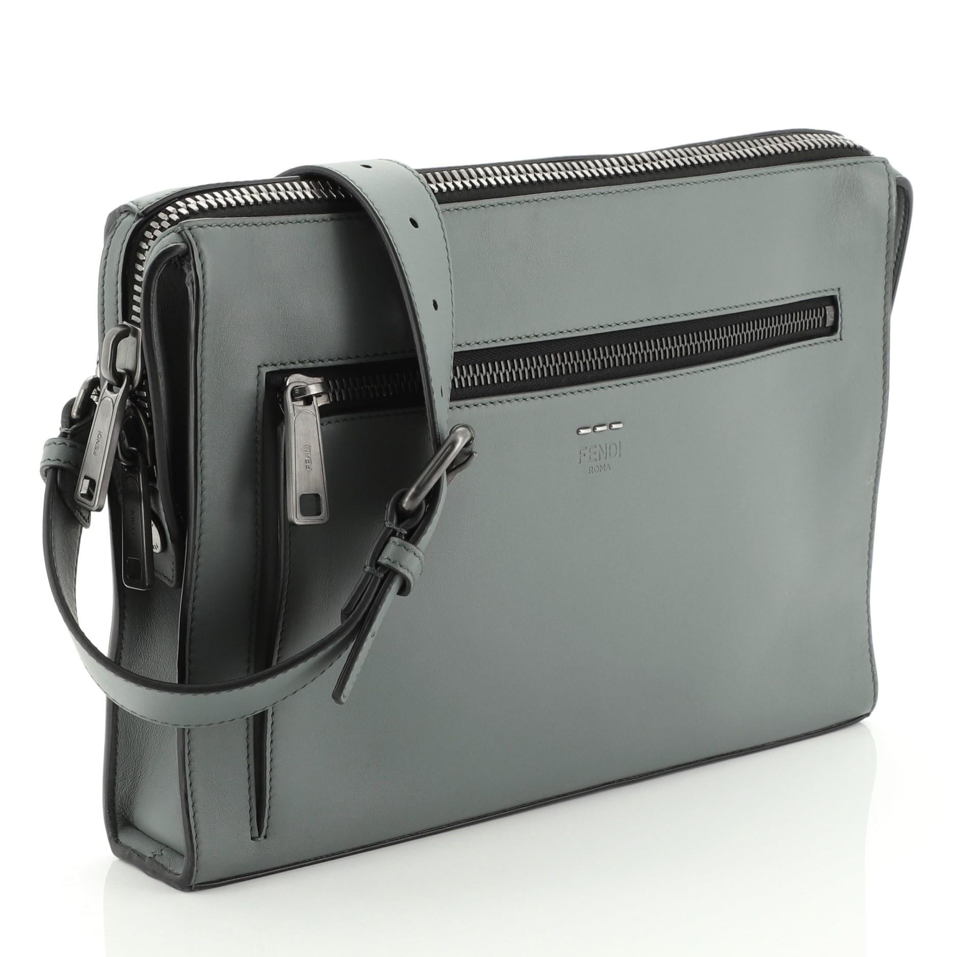 This Fendi Convertible Document Holder Leather Medium, crafted in green leather features an adjustable shoulder strap, exterior front zip pocket and gunmetal-tone hardware. Its zip closure opens to a black fabric interior with zip and slip pockets.
