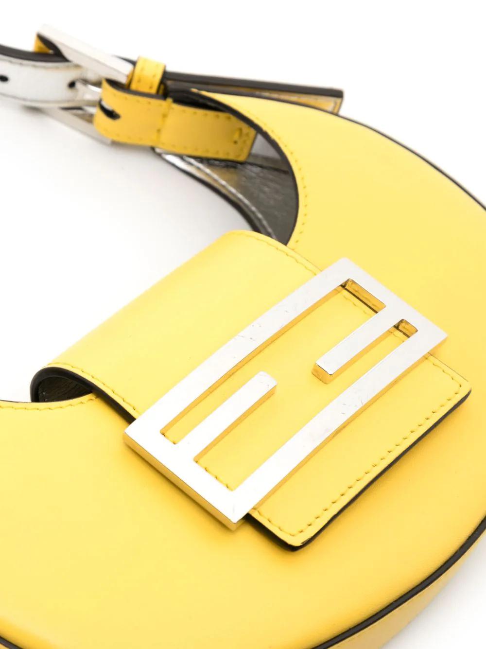 Trendy Cookie Yellow Handbag crafted in Italy with 100% leather in a curvy-edge body. FF logo plaque in silver-tone as well as the hardware. Magnetic strap fastening and adjustable top handle. The condition of this mini bag is excellent with no