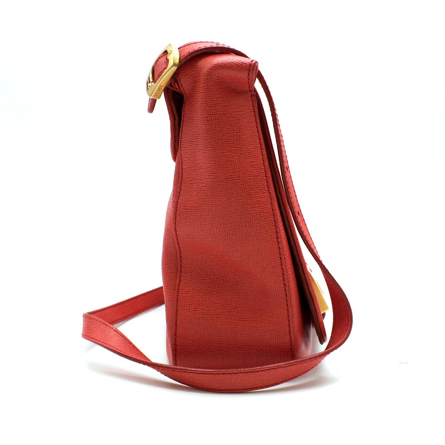 Fendi coral coated canvas crossbody fold-over bag.
The bag is lightweight and features gold toned hardware details. 
The interior is lined with monogrammed canvas and red suede and features one zipped pocket and two unzipped compartments.
