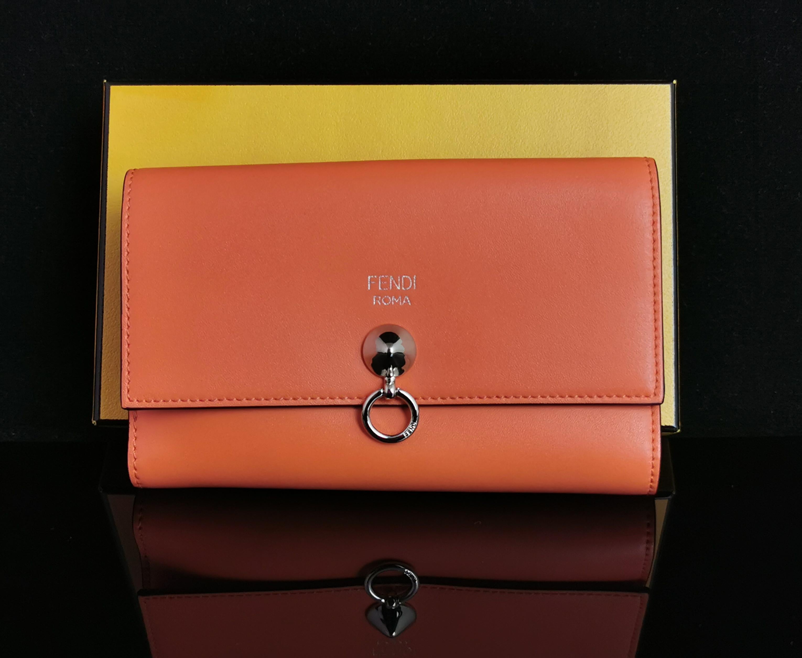 A gorgeous Fendi bi fold coral calf leather clutch purse or wallet.

Front and back compartments with a space for cards and other compartments to the front.

Soft and vibrant coral coloured leather, the perfect spring /summer piece but this is just