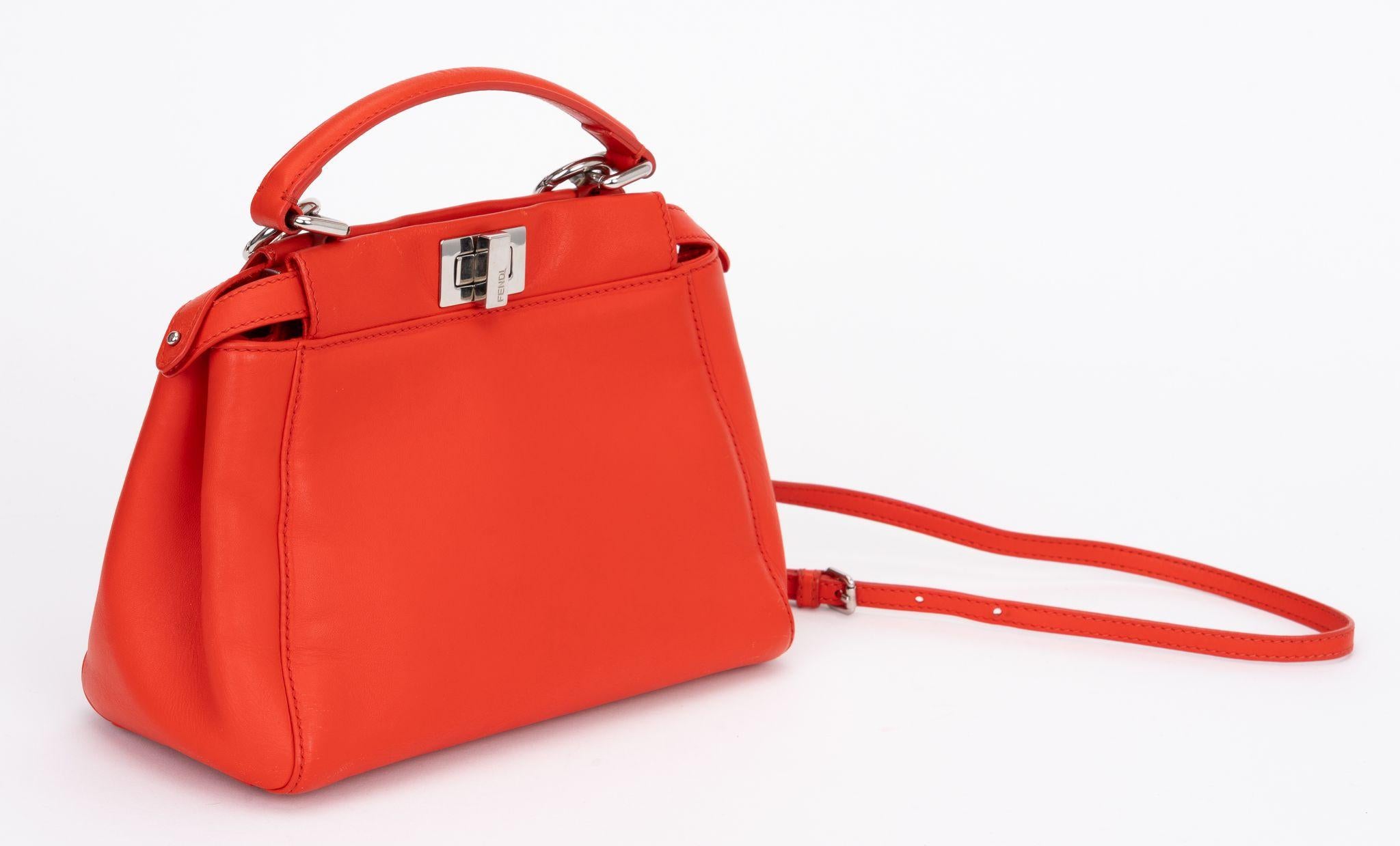 Fendi coral leather mini peekaboo cross body bag. Excellent condition, two open side pockets and one center closed compartment. 
Handle drop 4