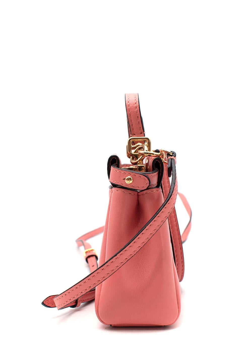 Fendi Coral-Pink Leather Mini Pocket Peekaboo Bag

- Micro itineration of the iconic Peekaboo bag
- Gold-tone metal twist lock, opens to 2 compartments and slip pocket
- Flat, single top handle, and adjustable, removable crossbody strap

Materials: