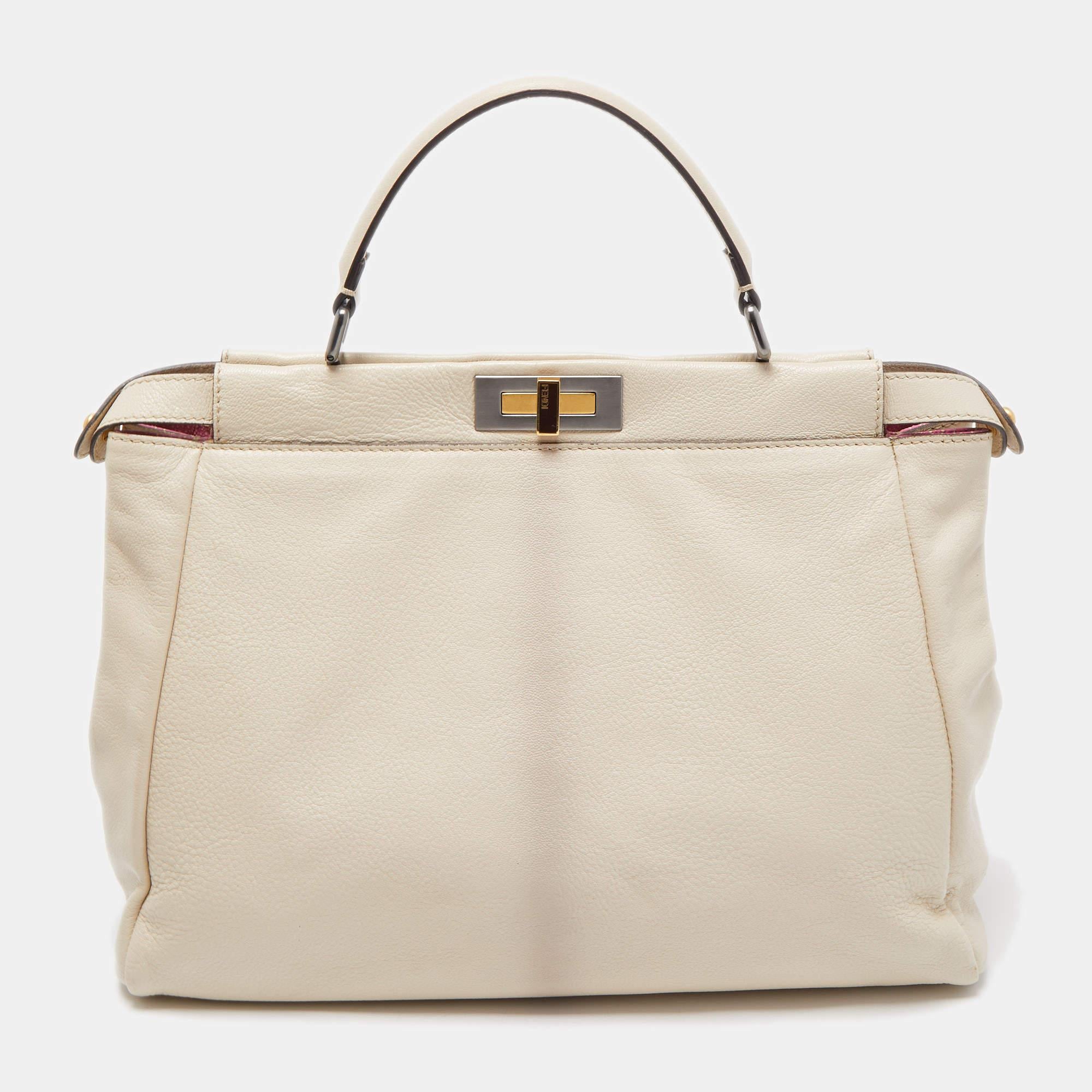 This exquisite Peekaboo from Fendi is highly coveted, and since its birth in 2009, it has swayed us with its shape, design, and beauty. This version comes meticulously crafted from leather and is designed with a top handle for you to swing it. A