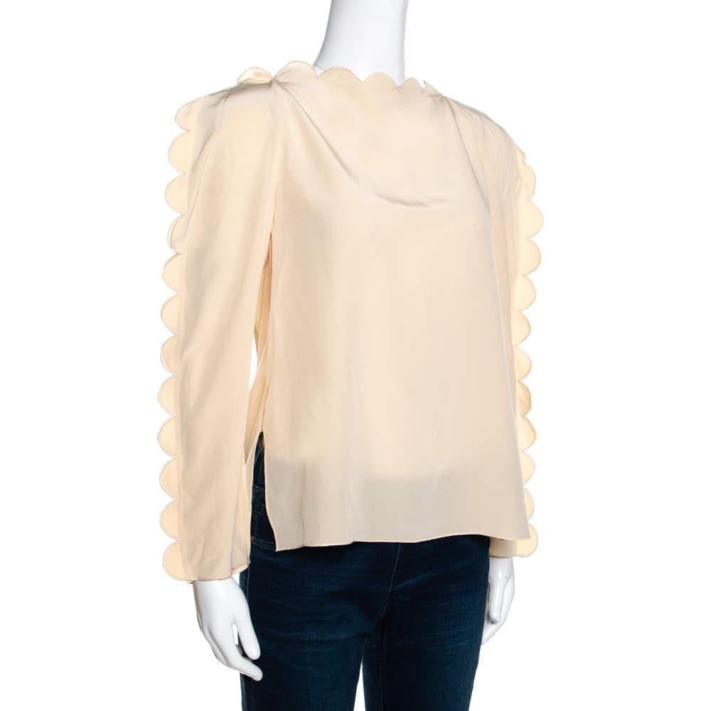 This blouse from Fendi would surely be a significant addition to your collection. This smart and sophisticated cream piece, with its artistic design, is a great choice. Tailored from quality fabrics, this blouse is a perfect blend of fashion and