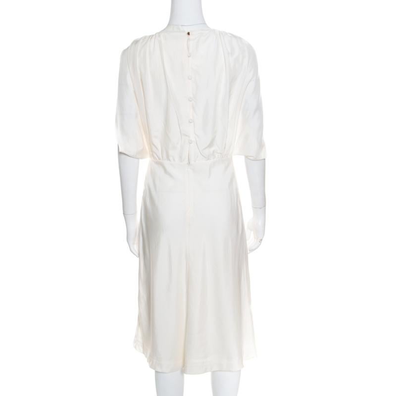 Make a pretty style-statement with this glorious dress from the house of Fendi. This pure silk dress is an ideal balance between absolute style and unconquerable charm. Designed for a contemporary chic look, this cream dress is perfect for any