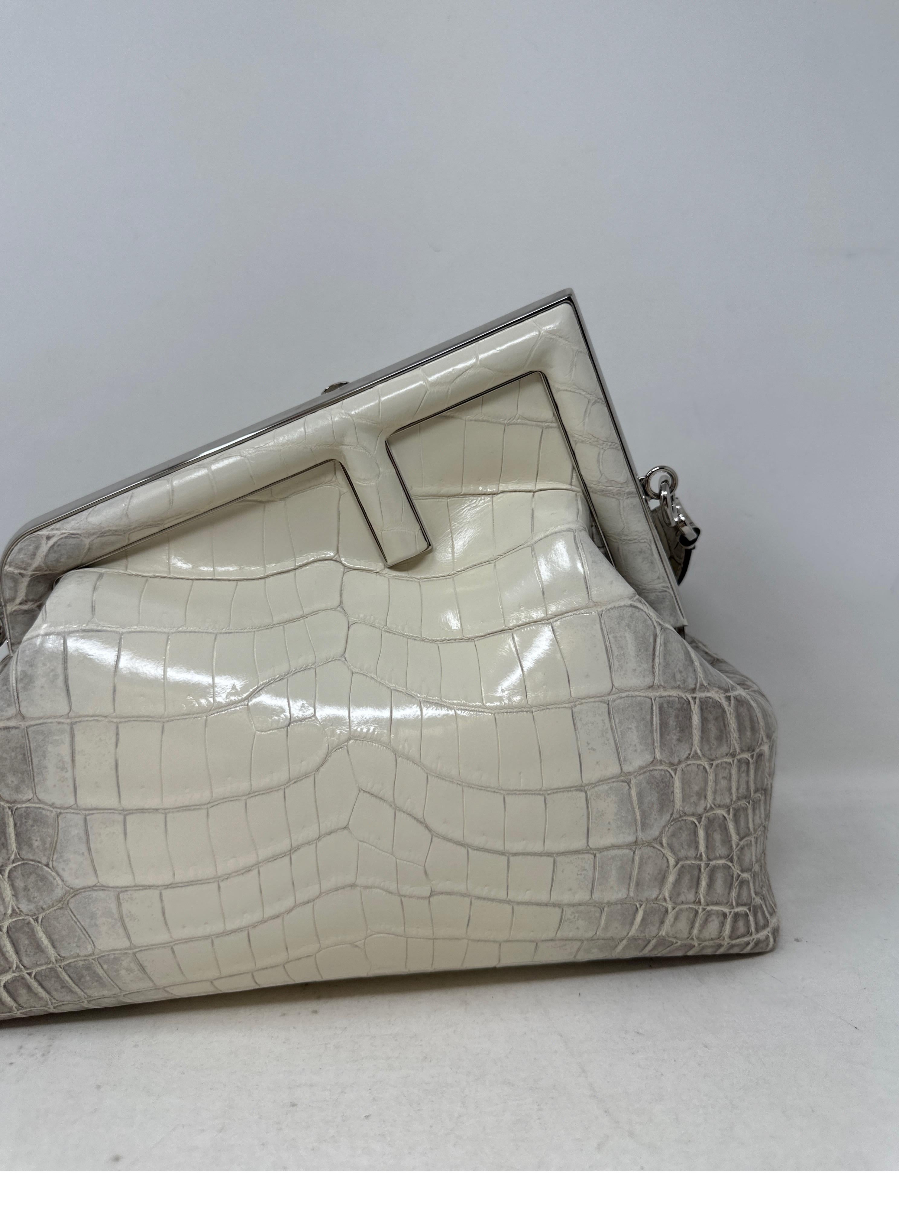 Fendi Medium size First Bag. Made of exotic natural crocodile leather painted white. Interior is lined in soft nappa leather. Palladium silver hardware details. The strap can be taken off and the bag can be worn as a clutch. Oversized F clasp adorns
