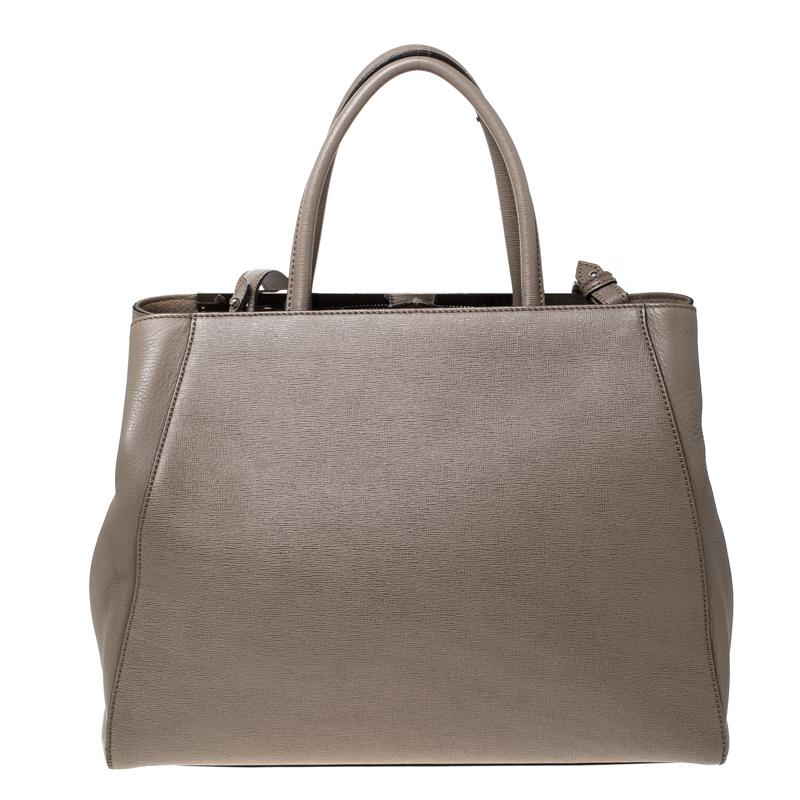 One of the most iconic designs from Fendi, the 2Jours tote continues to receive the love of women around the world. Crafted from beige leather, the bag features double rolled handles. It is also equipped with a fabric and suede interior and finished