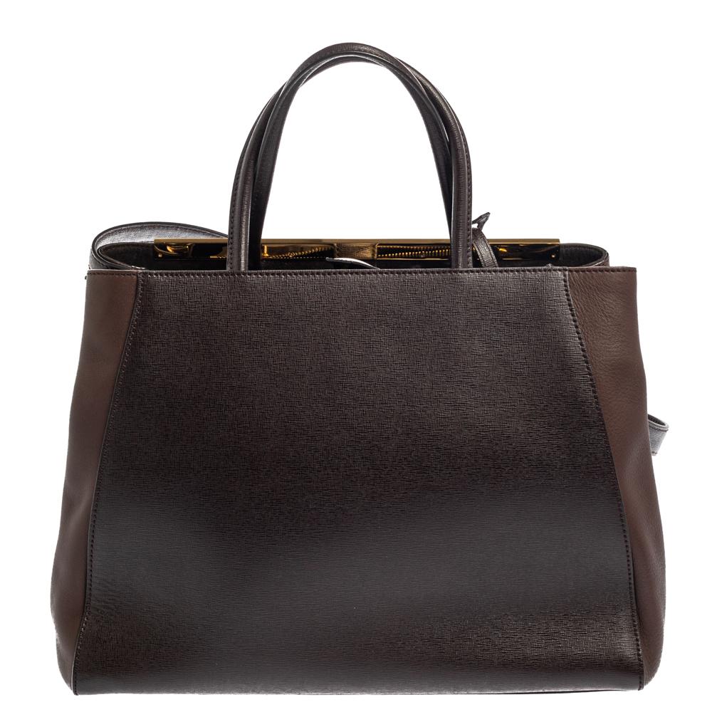 Fendi's 2Jours tote is an iconic design. Crafted from leather in a dark brown hue, the bag features a logo bar at the topline and can be carried with double rolled handles or a shoulder strap. A button closure opens to a fabric-lined interior that