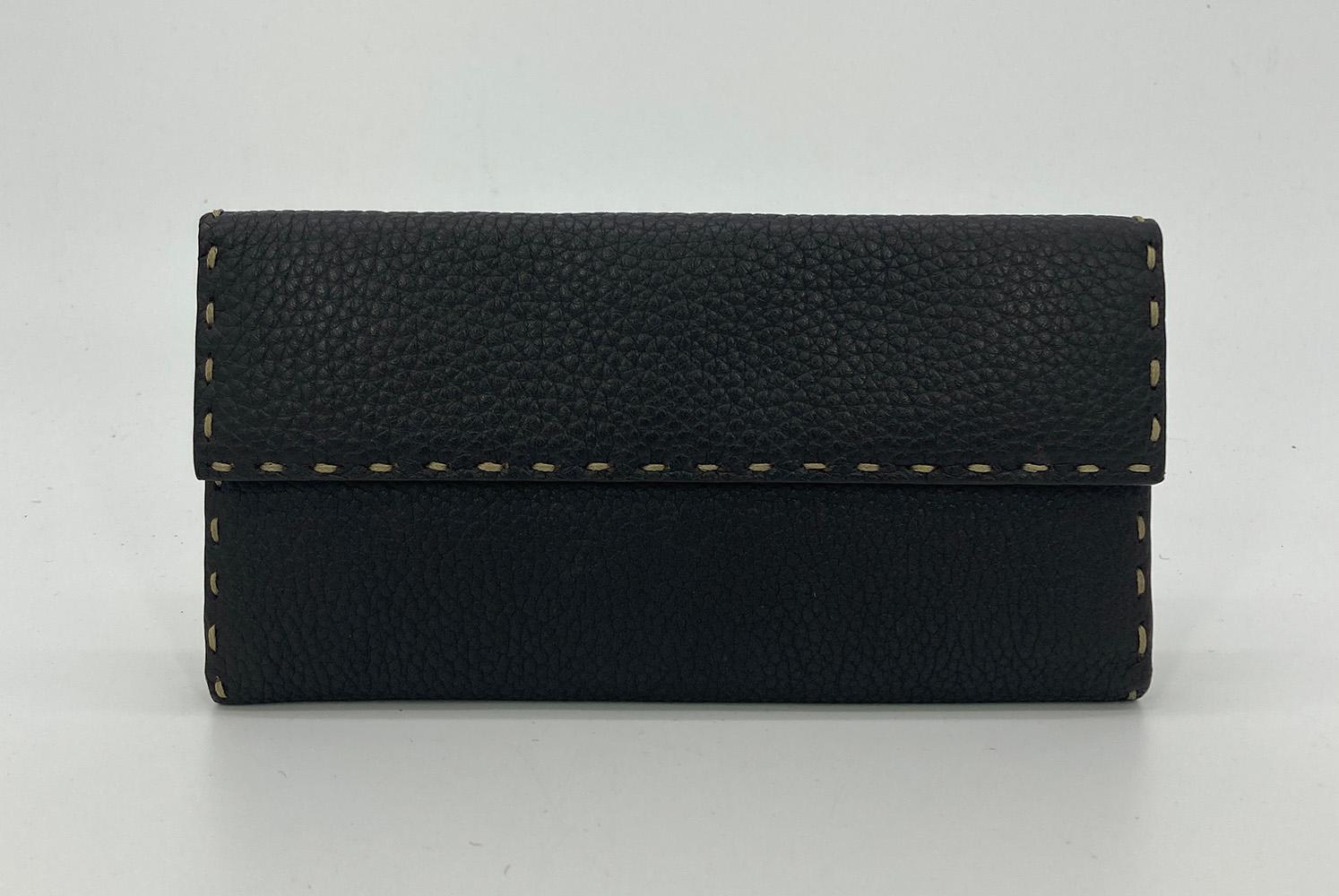Fendi Dark Brown Leather Continental Wallet in very good condition. Dark Brown Selleria leather with cream top stitching around edges. Front snap closure opens via double fold to a brown leather interior with clear frosted id pocket, 2 larger slit