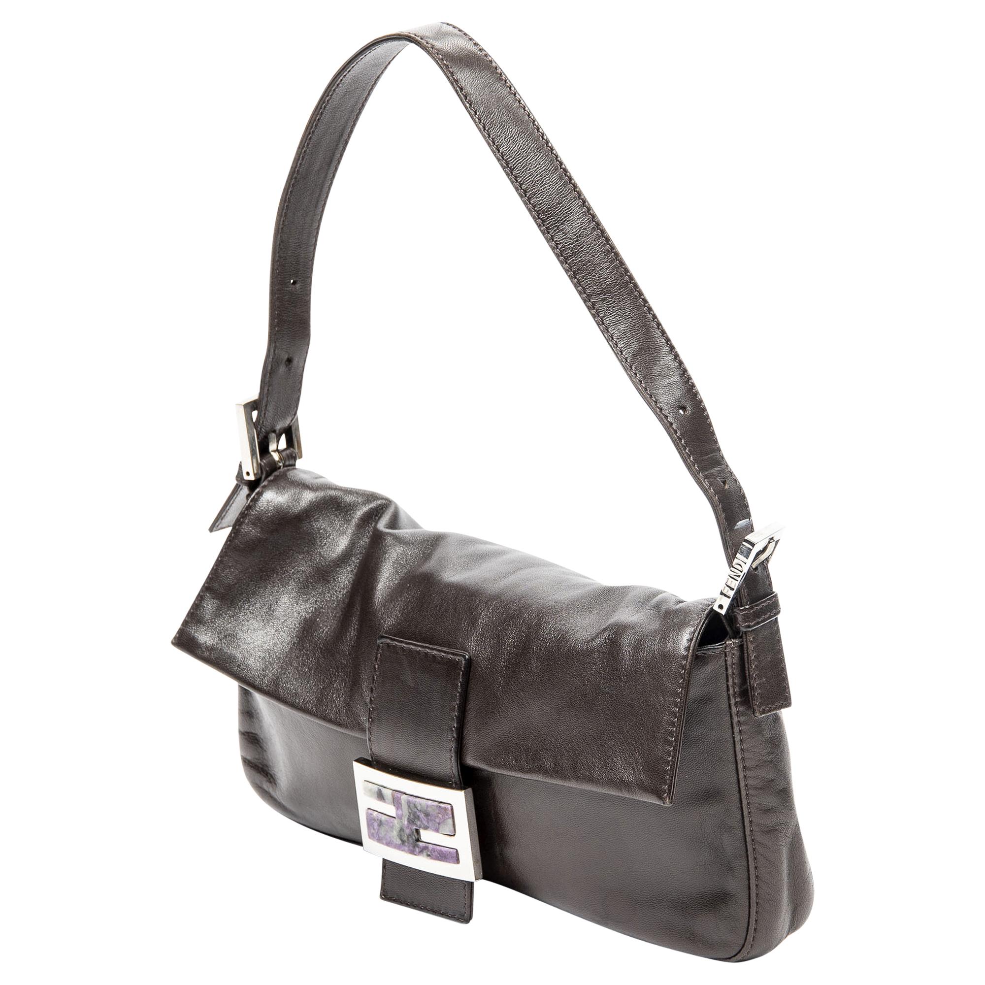 Elevate your look with the Mocha Muse Shoulder Bag. Crafted from luxurious dark brown calfskin leather, its smooth texture exudes sophistication. Adorned with sleek silver hardware, it features a practical magnetic snap closure for easy access.