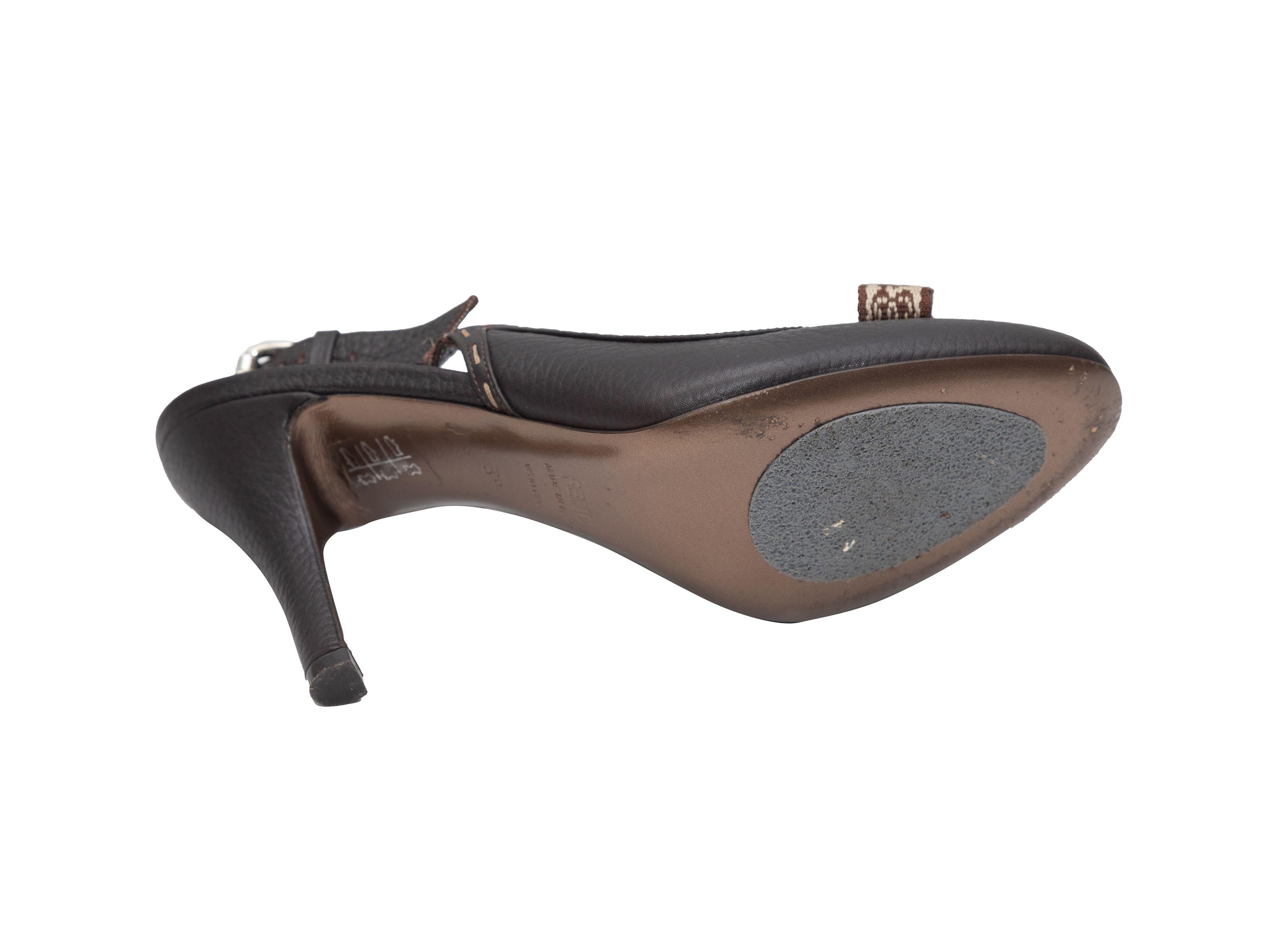 Product Details: Dark brown Selleria slingback heels by Fendi. Silver-tone buckle closures at slingback straps. 3.75