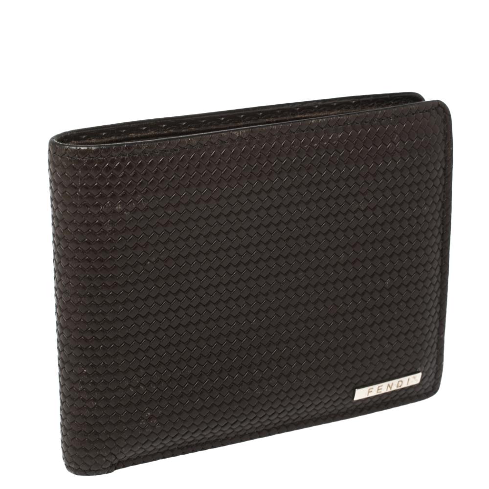 A perfect size wallet to carry in your bag or just in your pants; this Fendi bi-fold wallet is an essential piece to own. Crafted in woven-embossed leather, this dark brown wallet features a silver-tone Fendi logo at the front, with compartments on