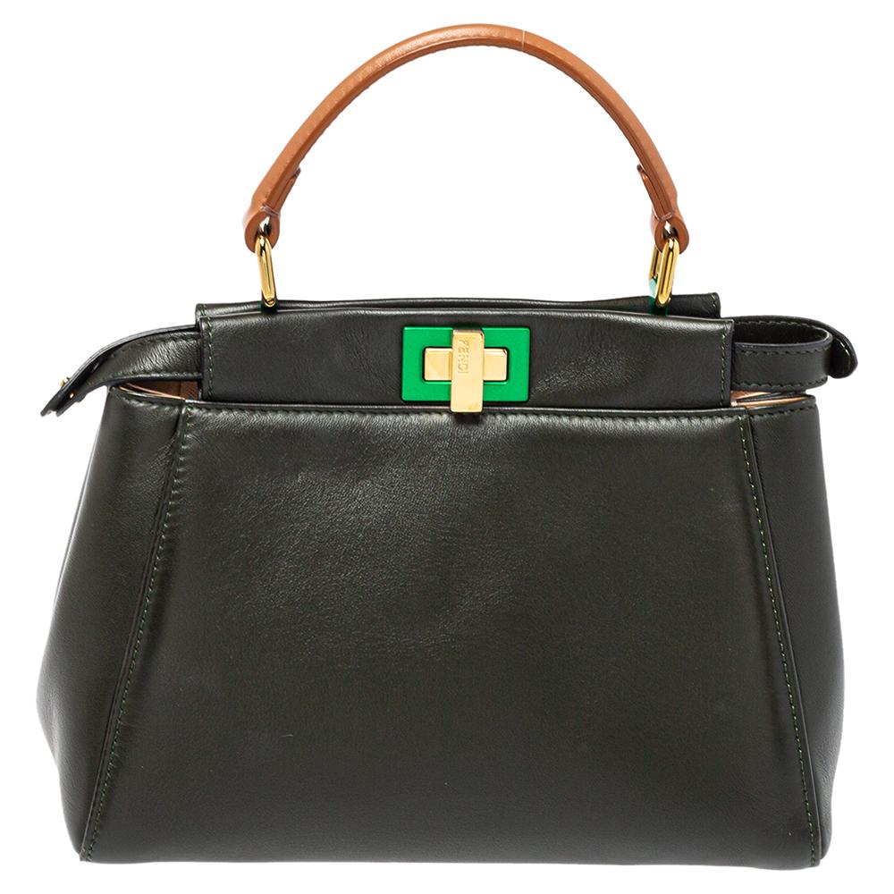 This exquisite Peekaboo from Fendi is highly coveted, and since its birth in 2009, it has swayed us with its shape, design, and beauty. This version comes meticulously crafted from leather and is designed with a top handle to swing it. A twist-lock