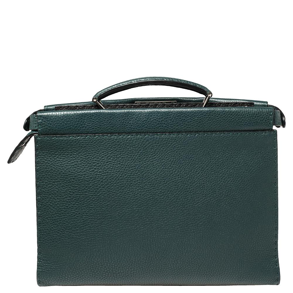 This exquisite Peekaboo briefcase from Fendi has swayed us with its shape, design, and appeal. This version comes meticulously crafted from leather and designed with a top handle. The bag opens grandly into a compartment lined with suede, making us