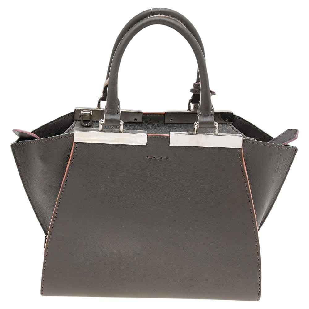 Fendi's 3Jours tote is one of the most iconic designs from the label and continues to gain popularity globally. This version is made from dark khaki leather, which is embellished with silver-toned hardware. It has dual handles and a spacious