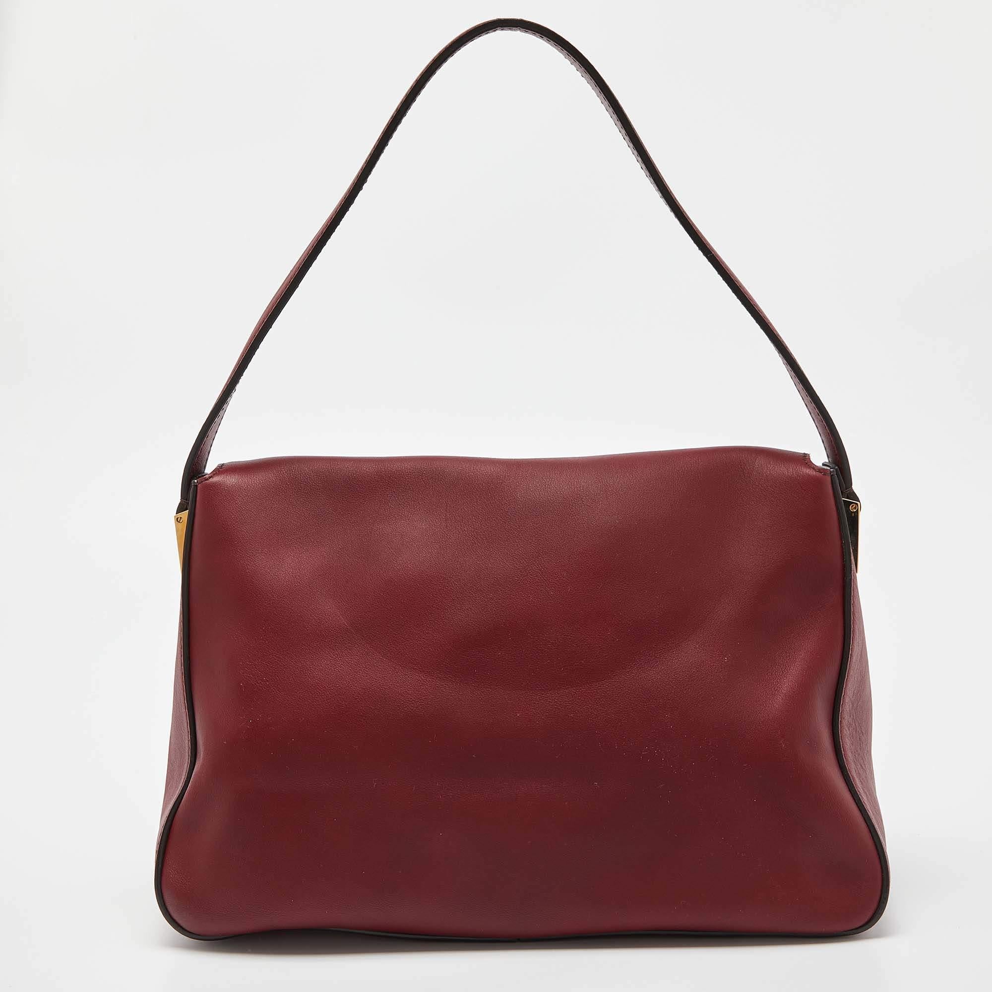The Mama Forever shoulder bag from Fendi is a classic fashion choice. Detailed with their logo lock on the flap, this dark red leather piece is simple and stylish. A well-sized fabric interior and a leather handle complete the bag.

Includes: