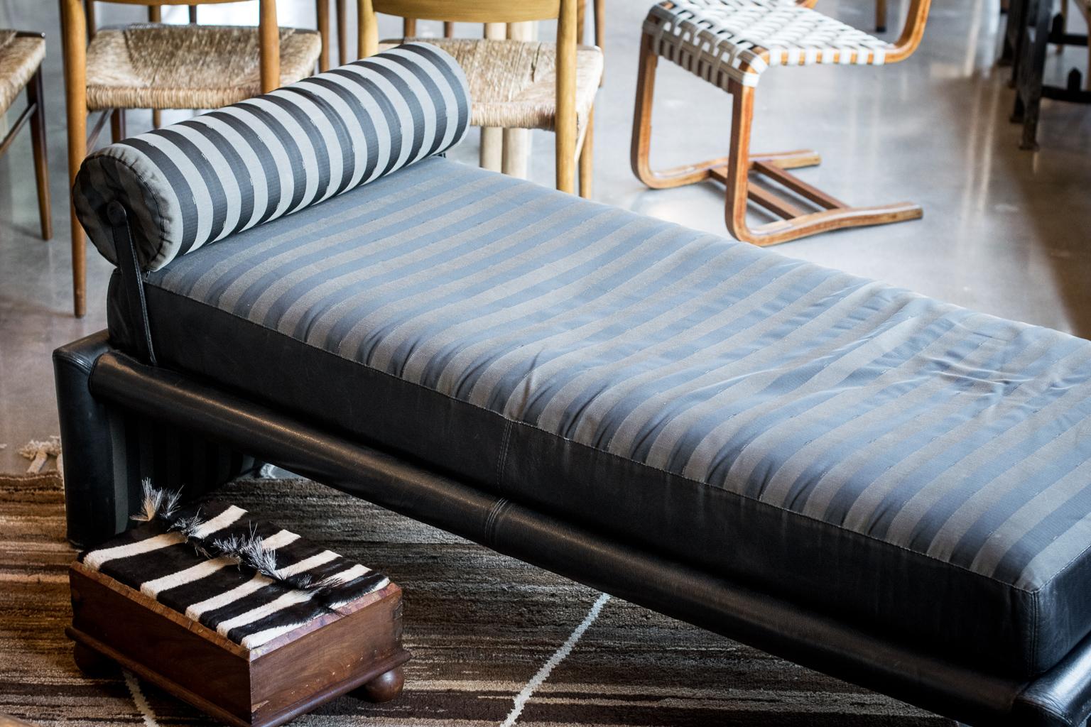 Daybed or chaise lounge by Fendi Roma, Italy, 1980s Heavy frame upholstered in black leather with thick cushion and bolster in Classic Fendi tonal stripe with leather trim. Makers label is present. Bolster pillow attaches with strap and can be moved