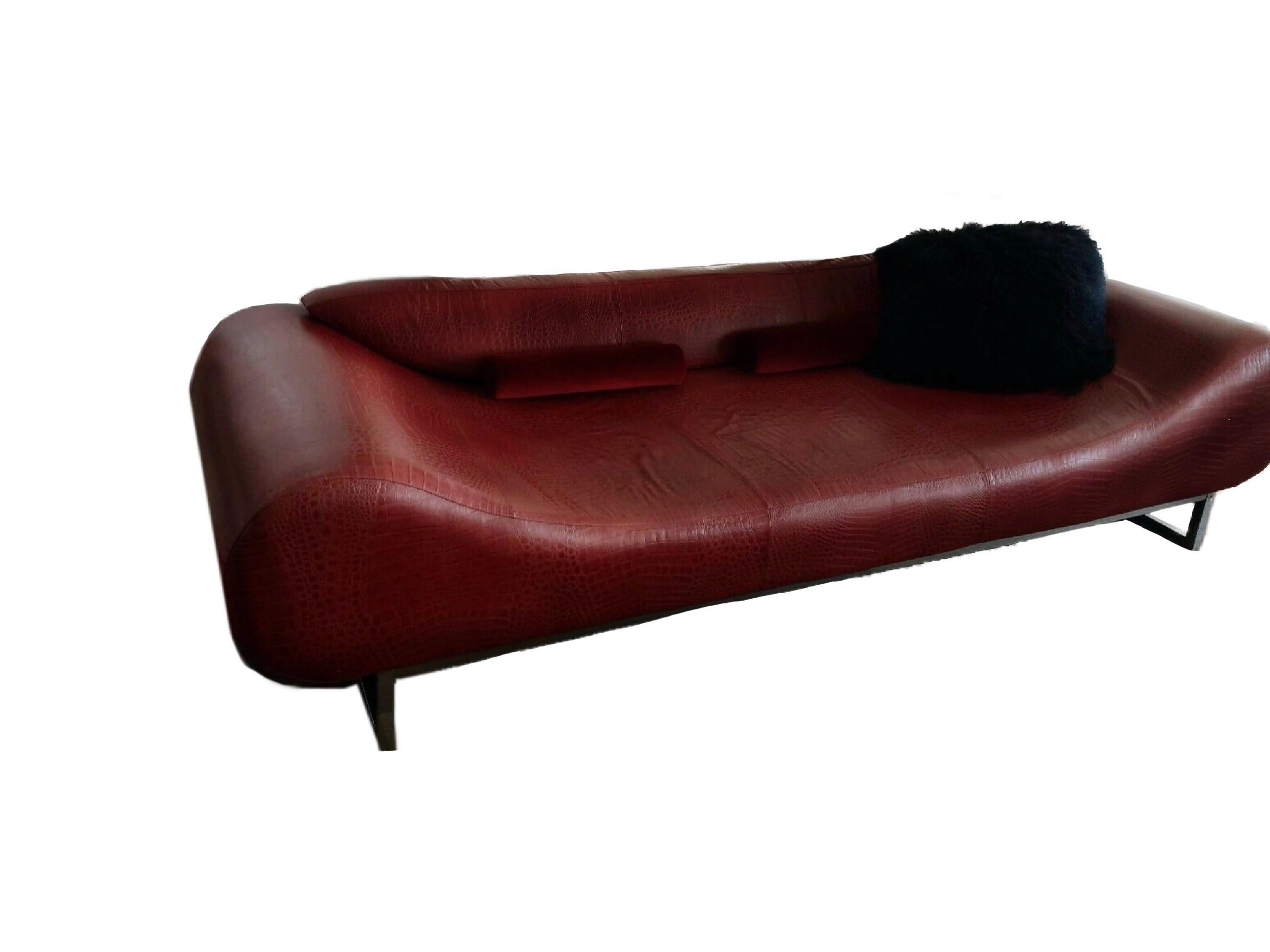 Fendi deep red chestnut leather organic modern ‘Eros’ Sofa, debuted in 2004.

Fendi casa Eros sofa with steel sleigh legs, adjustable back cushion, embossed pattern at upholstery and brand plaque at lower edge of arm.

MSRP 32,400 USD.