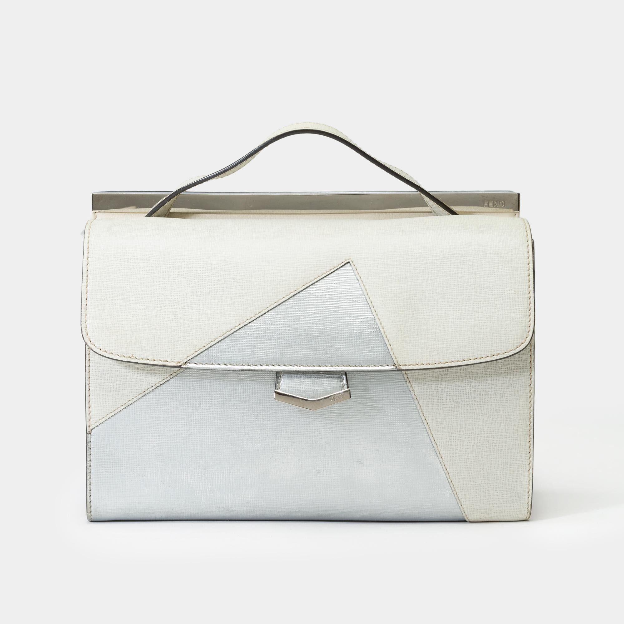 Charming​ ​“Demi​ ​Jour”​ ​handbag​ ​in​ ​two-tone​ ​off-white​ ​and​ ​silver​ ​leather,​ ​featuring​ ​a​ ​practical​ ​and​ ​versatile​ ​design​ ​perfect​ ​for​ ​day-to-day​ ​use.​ ​The​ ​bag​ ​includes​ ​an​ ​adjustable​ ​shoulder​ ​strap​ ​that​