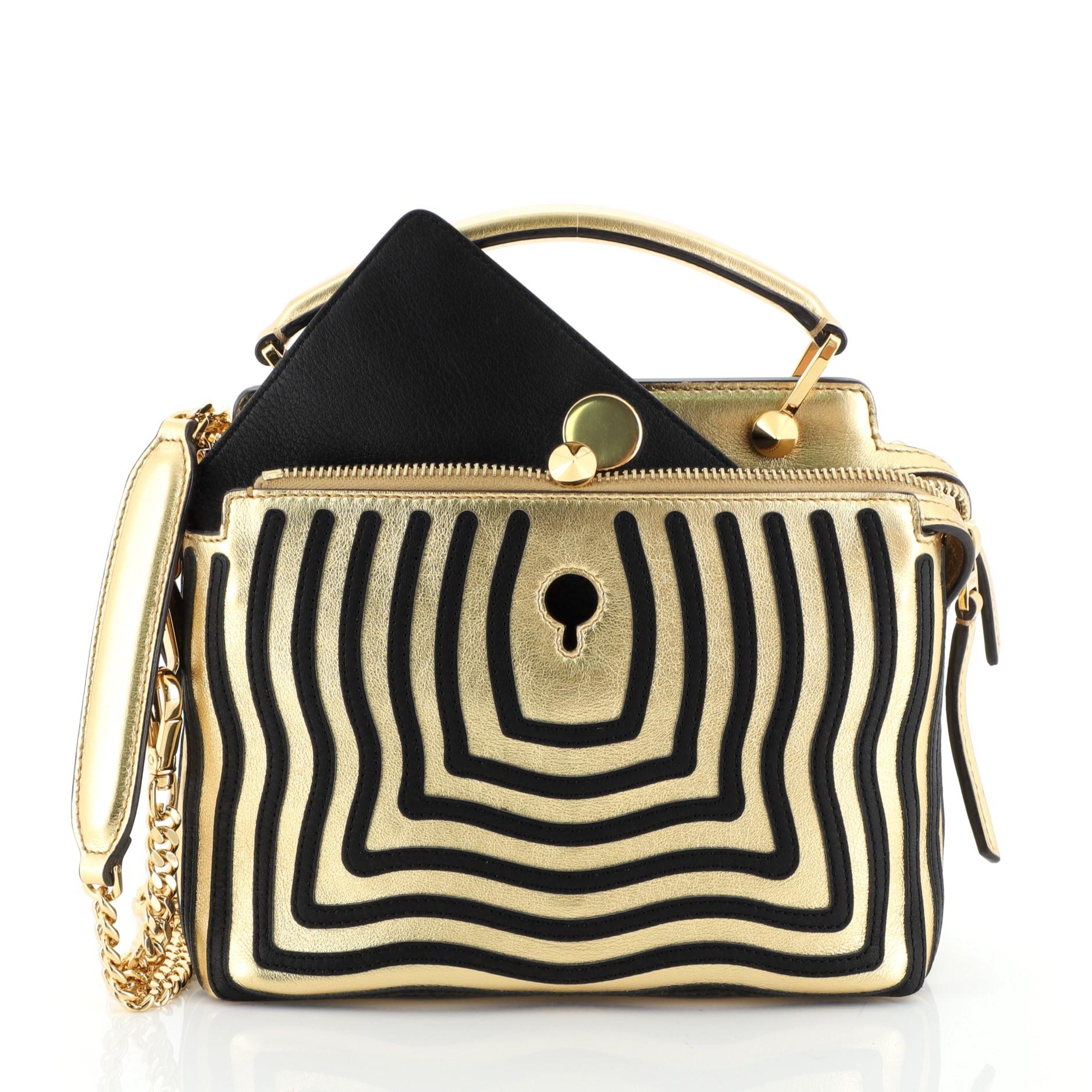 This Fendi DotCom Click Top Handle Bag Hypnotic Leather Small, crafted from gold leather, features dual chain straps with leather pads, two zip top compartments with snap ends, conical stud embellishment, and gold-tone hardware. Its extended zip