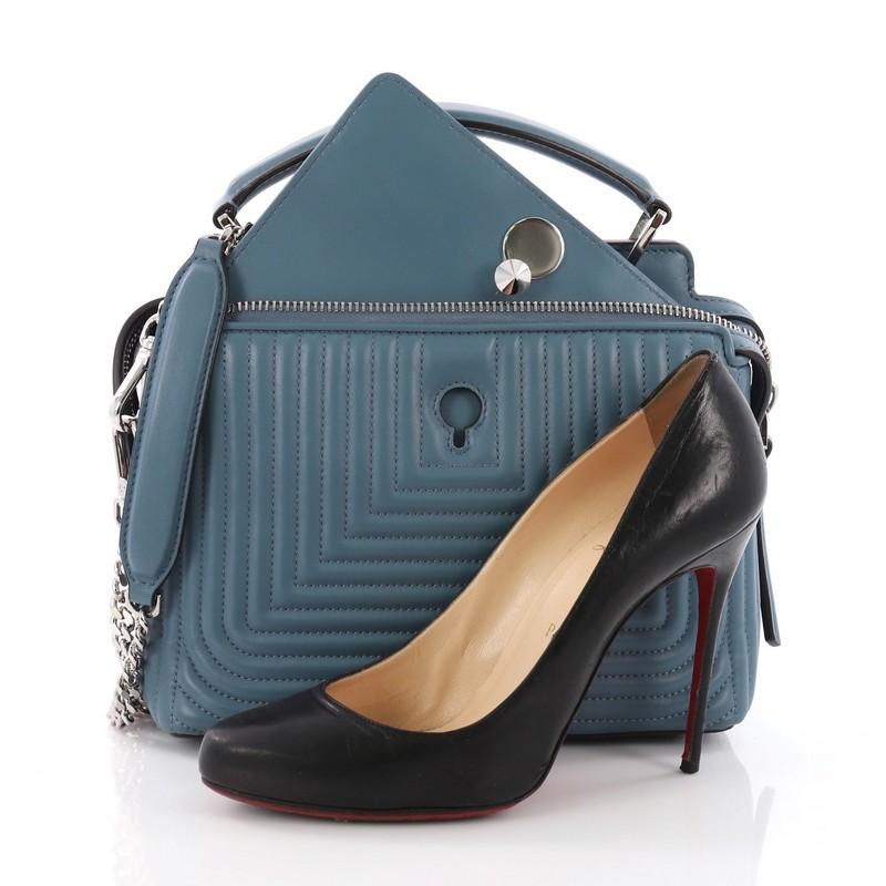 This Fendi DotCom Click Top Handle Bag Quilted Leather Small, crafted from blue geometric-quilted leather, features chain-link shoulder strap, two zip top compartments with snap ends, distinctive conical stud embellishment, and silver-tone hardware.