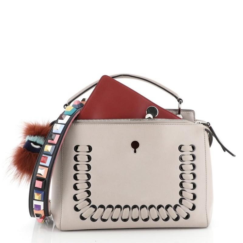 This Fendi DotCom Convertible Satchel Whipstitch Leather Medium, crafted from neutral leather, features a flat top handle, distinctive conical stud embellishment, whipstitch detailing, and silver-tone hardware. Its extended zip closure with snap